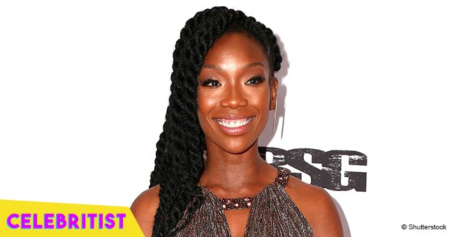 Brandy flaunts fuller curves in mini orange dress after gaining weight