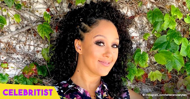 Tamera Mowry stuns in plunging black dress while on vacation with family