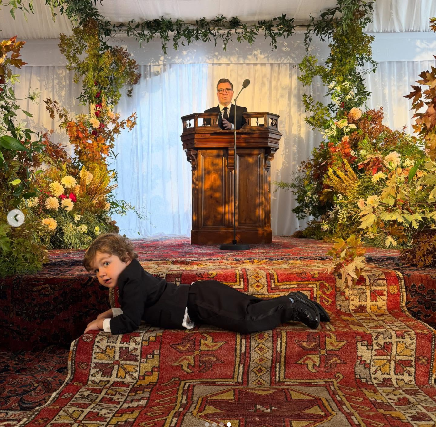 A child is sprawled across a patterned rug as an officiant stands in the background, from a post dated September 28, 2025 | Source: Instagram/itsbennyblanco