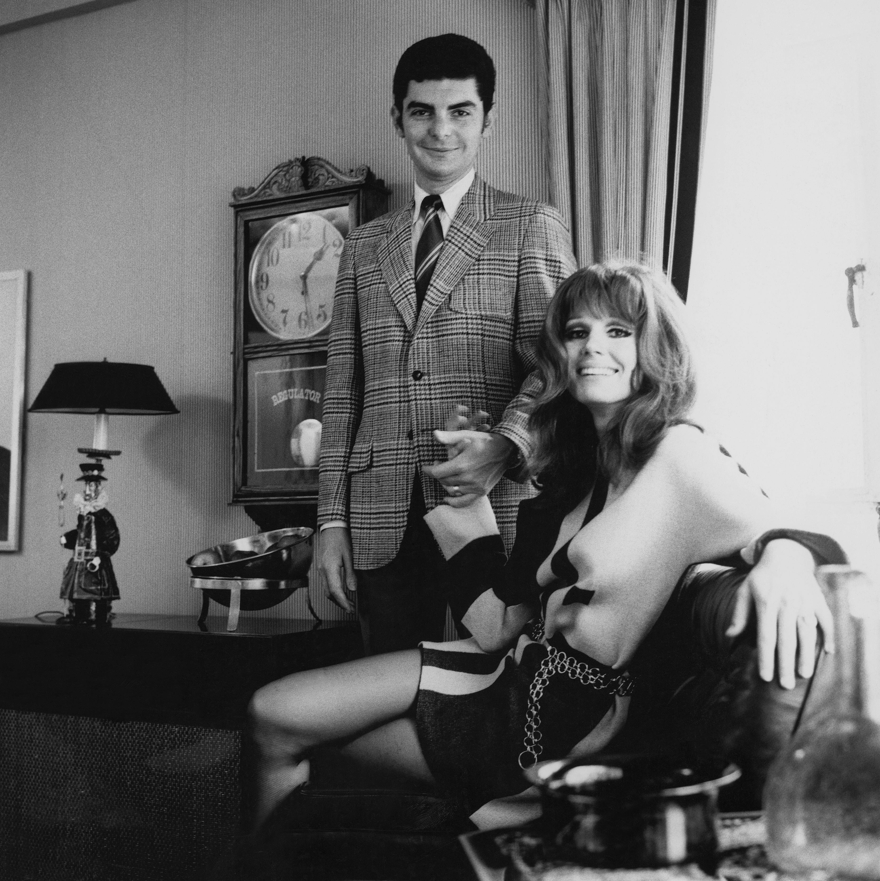 Photographed for GQ in 1968, the married actors pose in a stylish setting — Benjamin in a wide-lapeled, two-button wool jacket by Tarra Hall, and Prentiss seated confidently beside him.