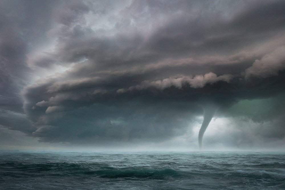 A huge storm takes form in the horizon, with a tornado roaming in open waters. I Image: Pixabay.