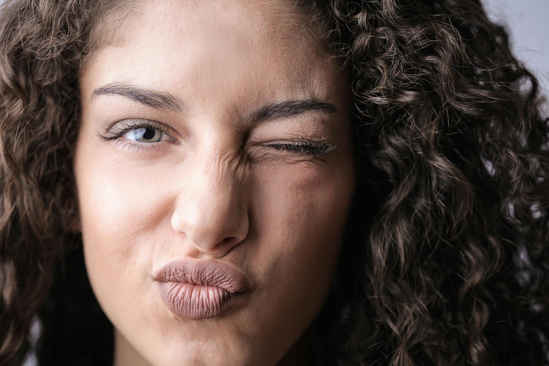 A woman winking | Source: Pexels