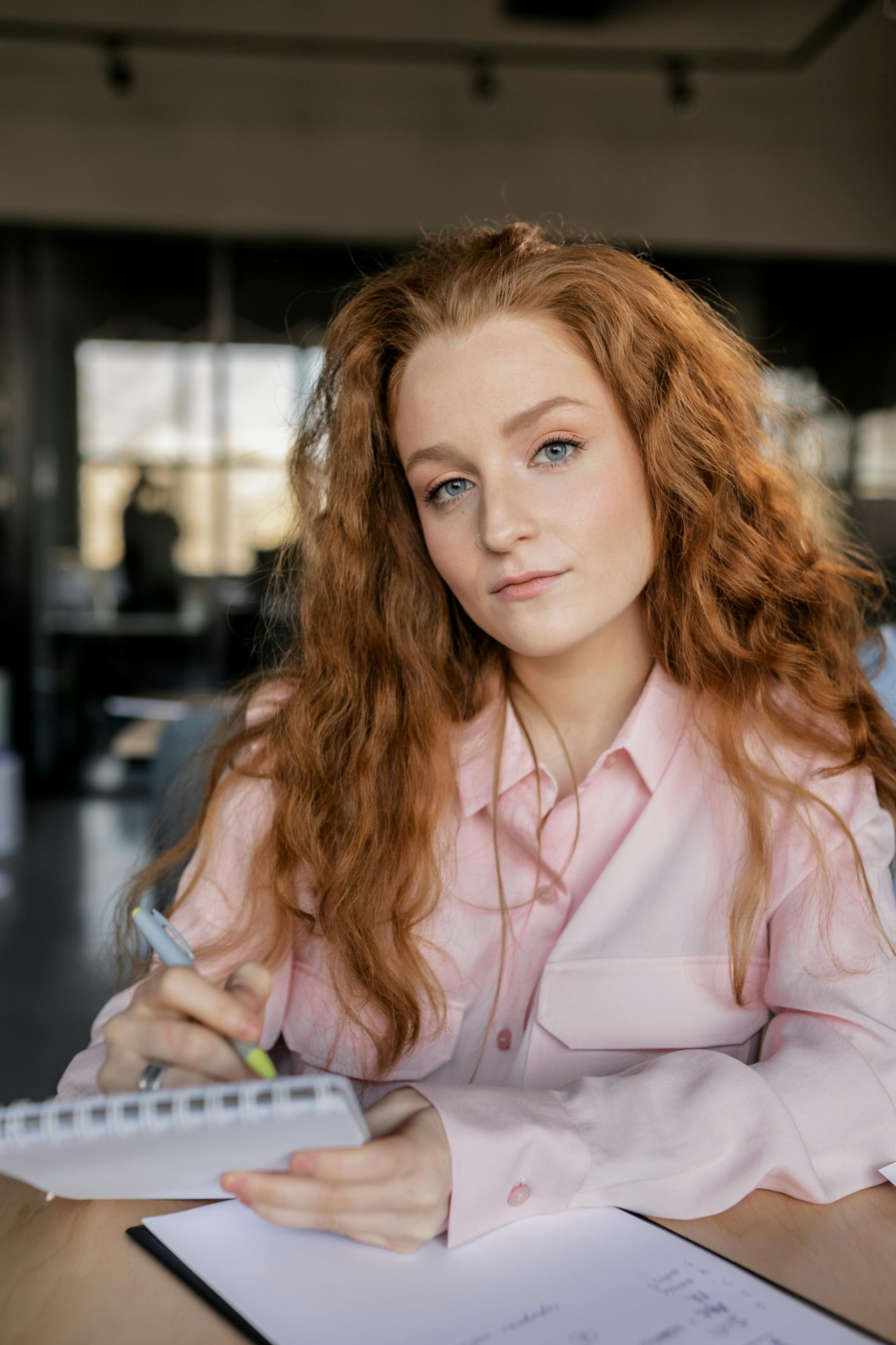 A woman holding a pen and notebook | Source: Pexels