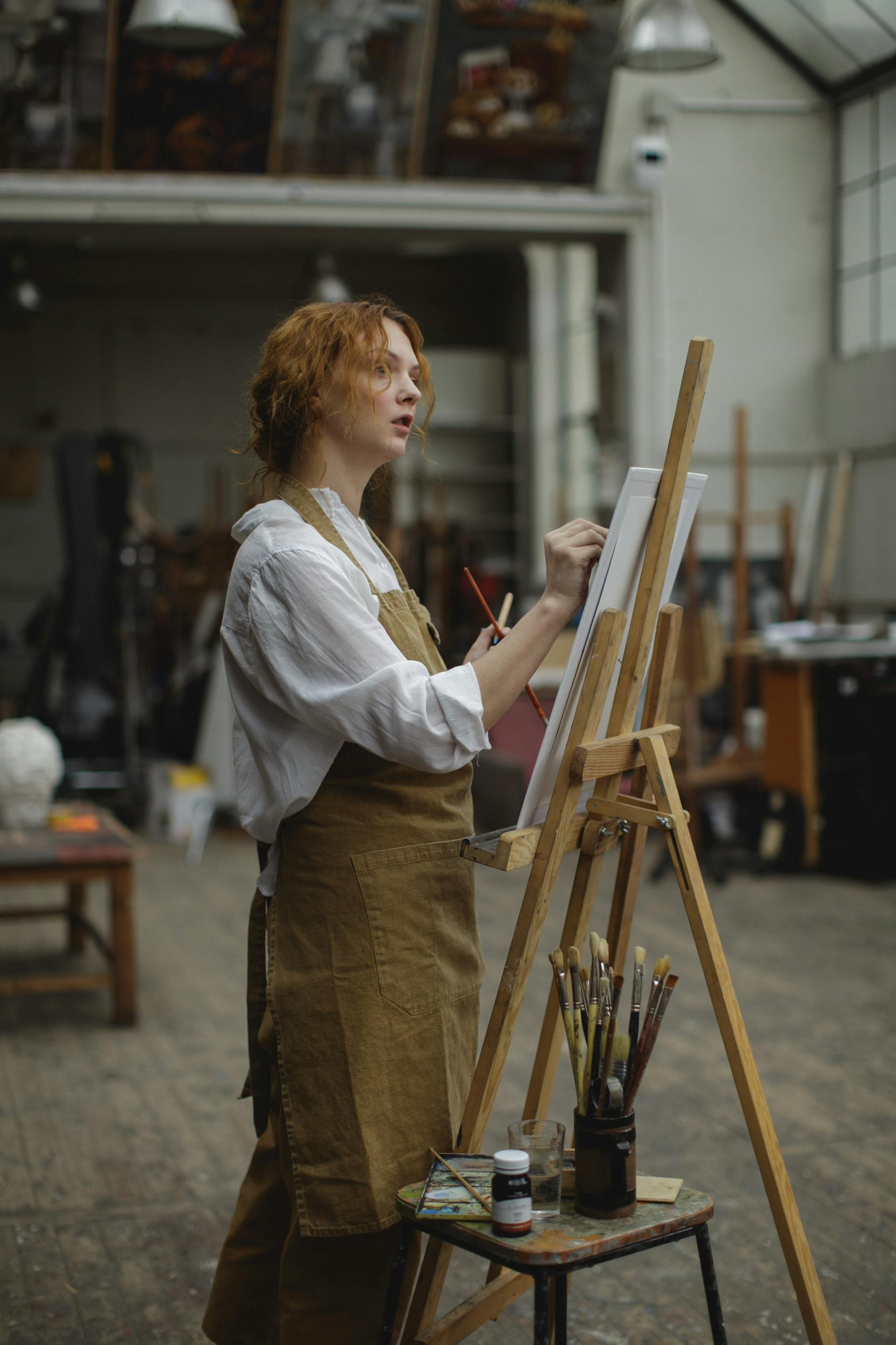 A woman painting on a canvas | Source: Pexels