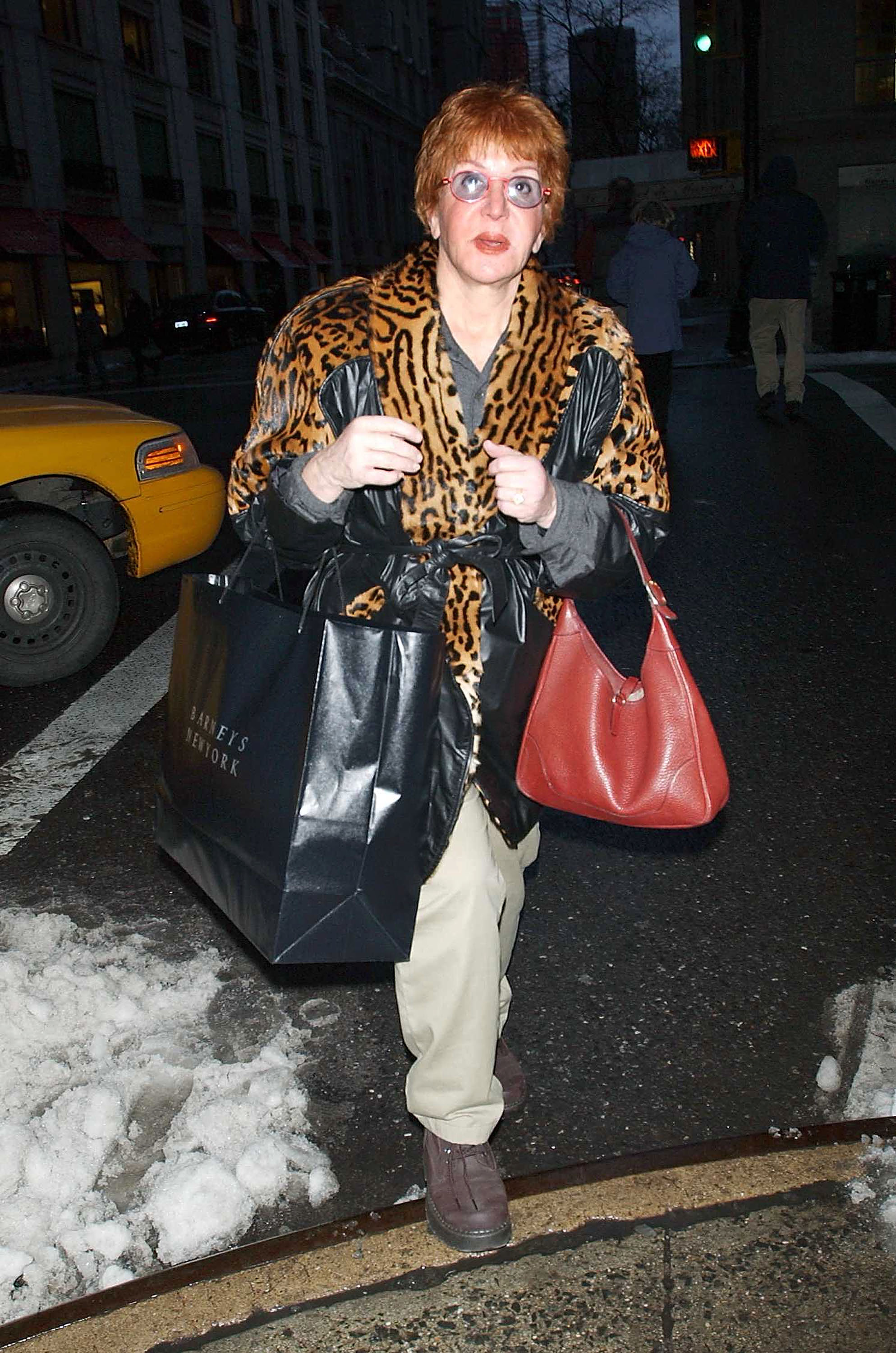 Sally Jessy Raphael is spotted walking along Madison Avenue after a shopping trip to Barneys department store in New York City on December 27, 2002. Dressed in a bold animal-print coat with leather accents, she carries shopping bags and a red handbag through the snowy street.