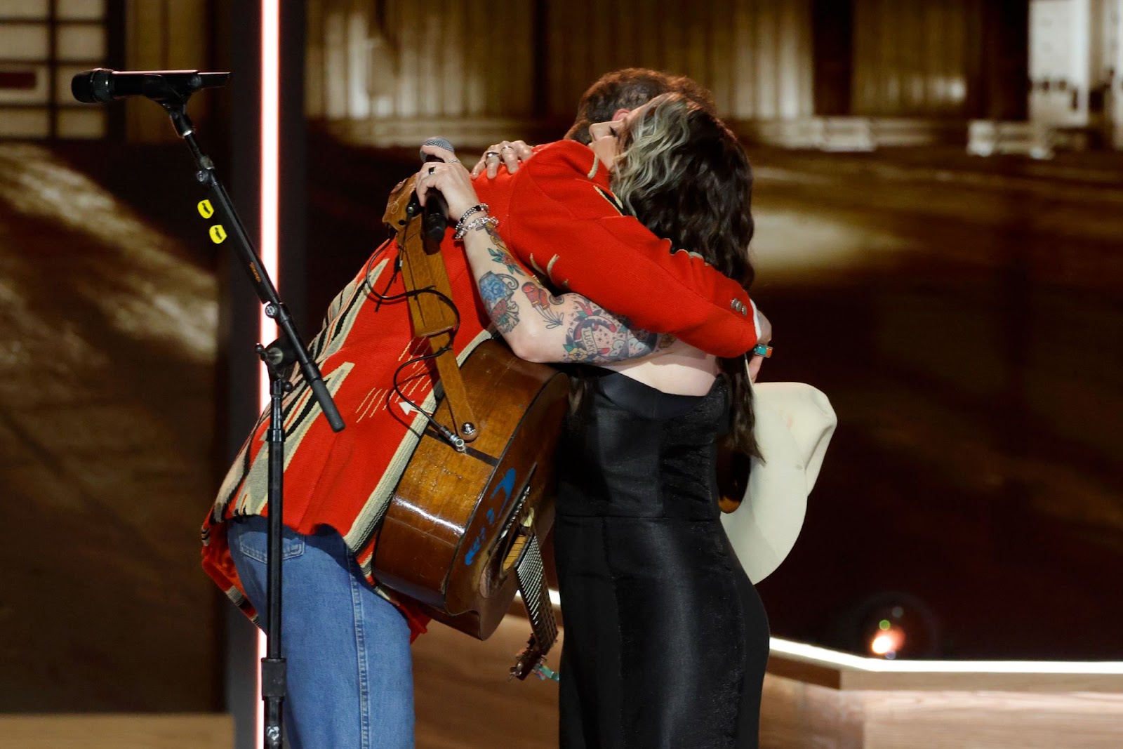 Post Malone and Ashley McBryde hug on stage | Source: Getty Images