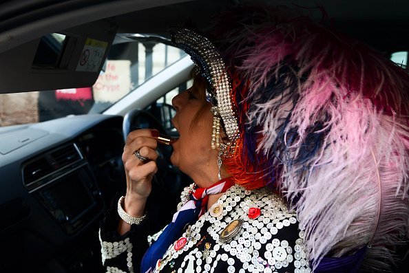 A pearly Queen applies her lipstick ahead of a church service at St Martin-in-the-Fields church I Photo: Getty Images