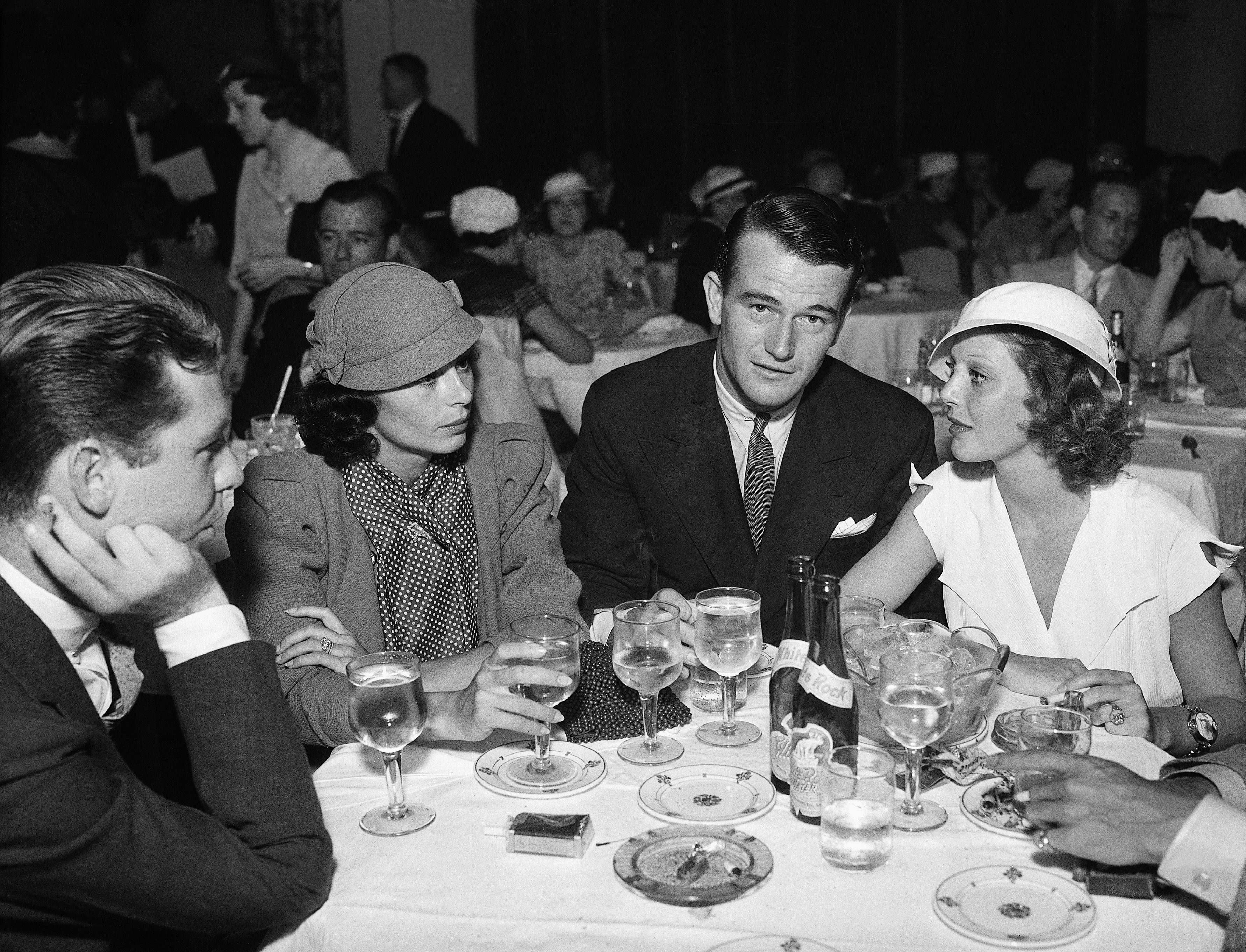 John Wayne, well-known screen actor, dines with his bride, the former Josephine Saenz, daughter of Dr. Jose S. Saenz, the Panamanian Consul in Los Angeles | Source: Getty Images
