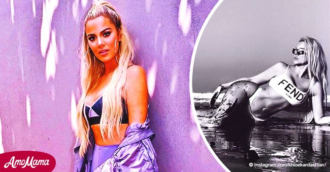 Khloé Kardashian flaunts her post-baby abs in a bikini, covering her curvy hips with wet sand
