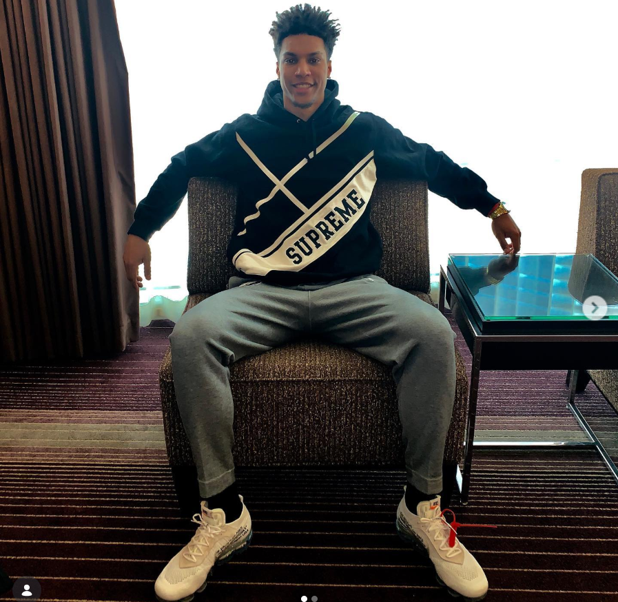 Brandon Clarke poses in a chair wearing a black Supreme hoodie and sneakers. | Source: Instagram/brandon_clarke23