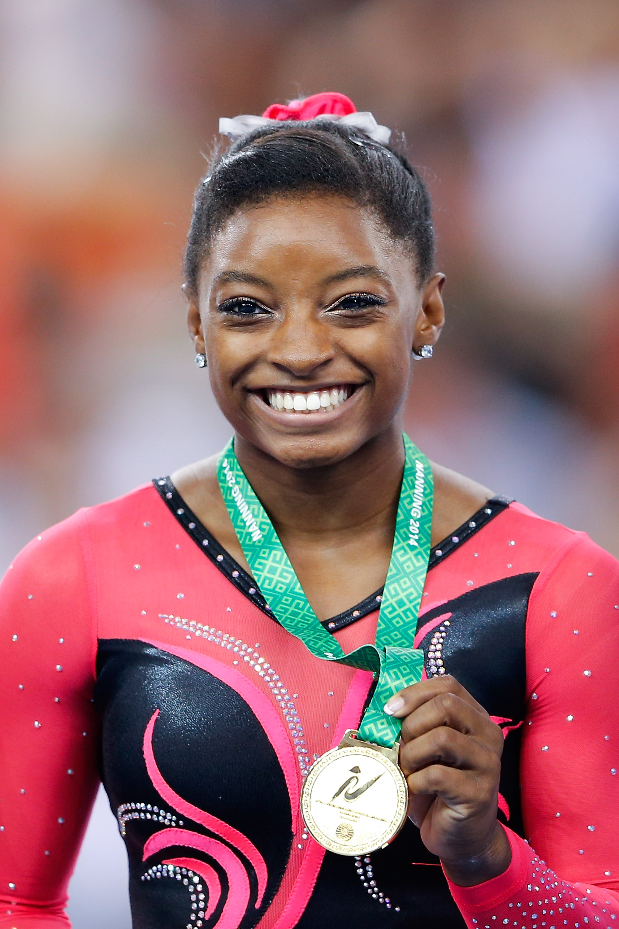 Simone Biles celebrates her gold win during the medal ceremony after Women's Balance Beam Final at the 45th Artistic Gymnastics World Championships on October 12, 2014, in Nanning, China | Source: Getty Images