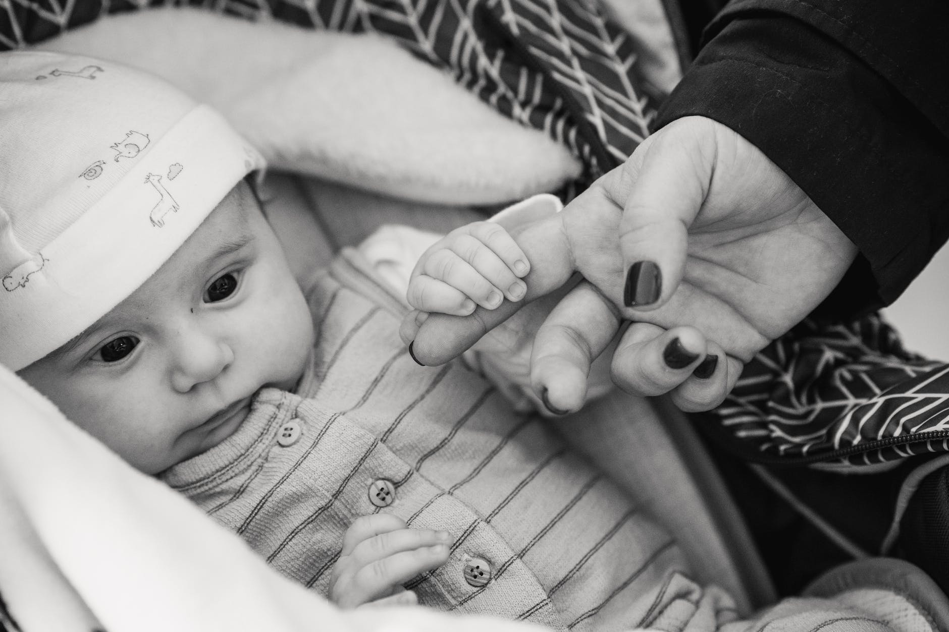 Bebé sosteniendo dedo de su mamá. | Foto: Pexels