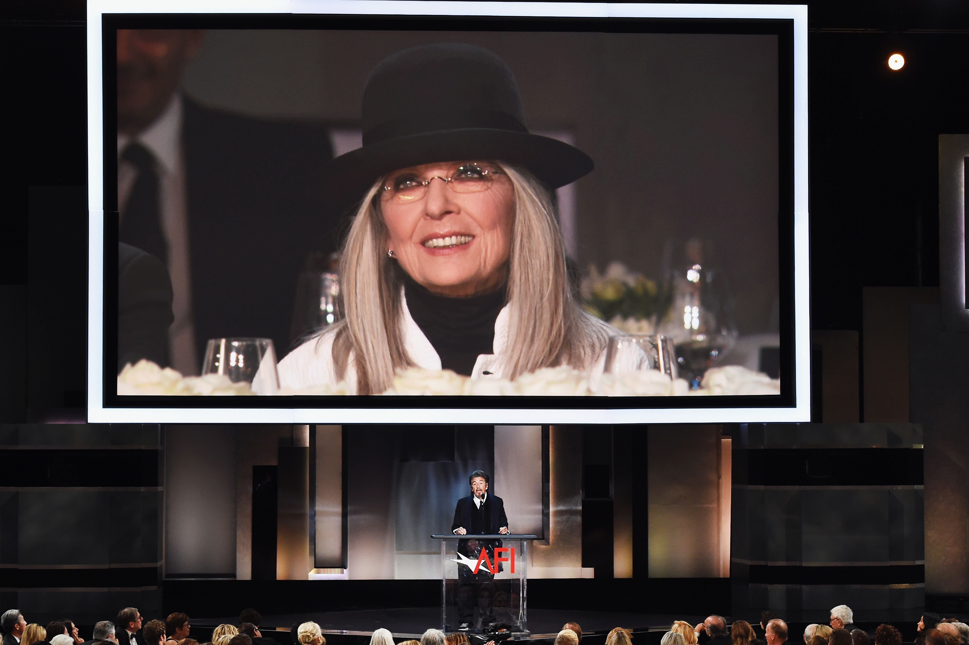 Diane Keaton projected on a video screen while Al Pacino speaks onstage during the American Film Institute's 45th Life Achievement Award Gala on June 8, 2017, in Hollywood, California. | Source: Kevin Winter/Getty Images