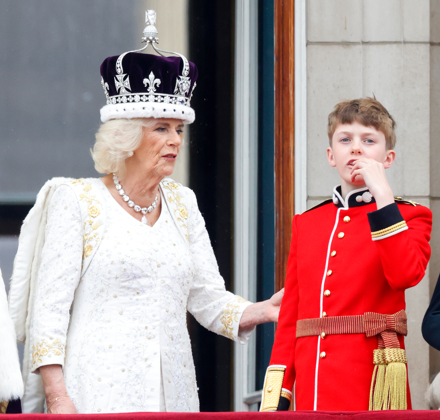 Queen Camilla talks to her grandson Freddy Parker Bowles at the Buckingham Palace, in London, following her coronation, on May 6, 2023. | Source: Getty Images