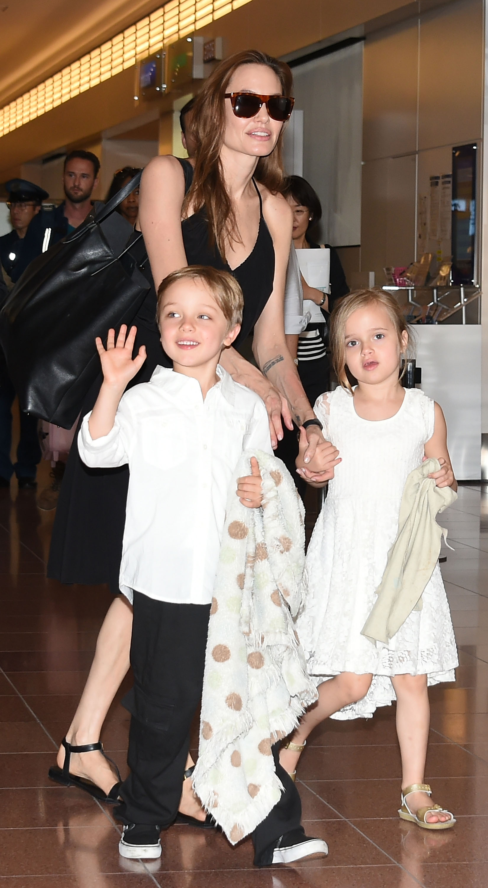 Angelina Jolie, Knox and Vivienne Jolie-Pitt arrive at Haneda Airport in Tokyo, Japan on June 21, 2014. | Source: Getty Images