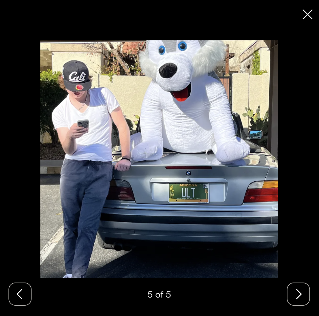 Evan Clark is pictured using his phone while standing next to a car | Source: gofundme