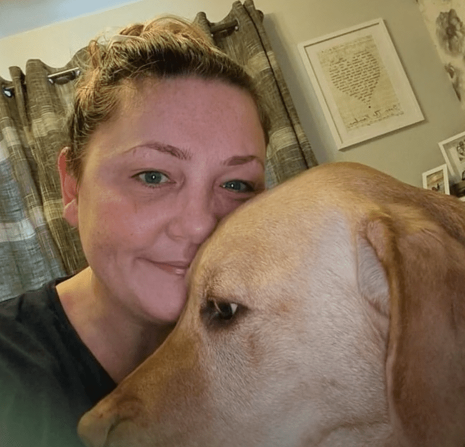 A woman and her dog who alerted her to the cancer in her breast | Photo: Youtube/Daily Mail