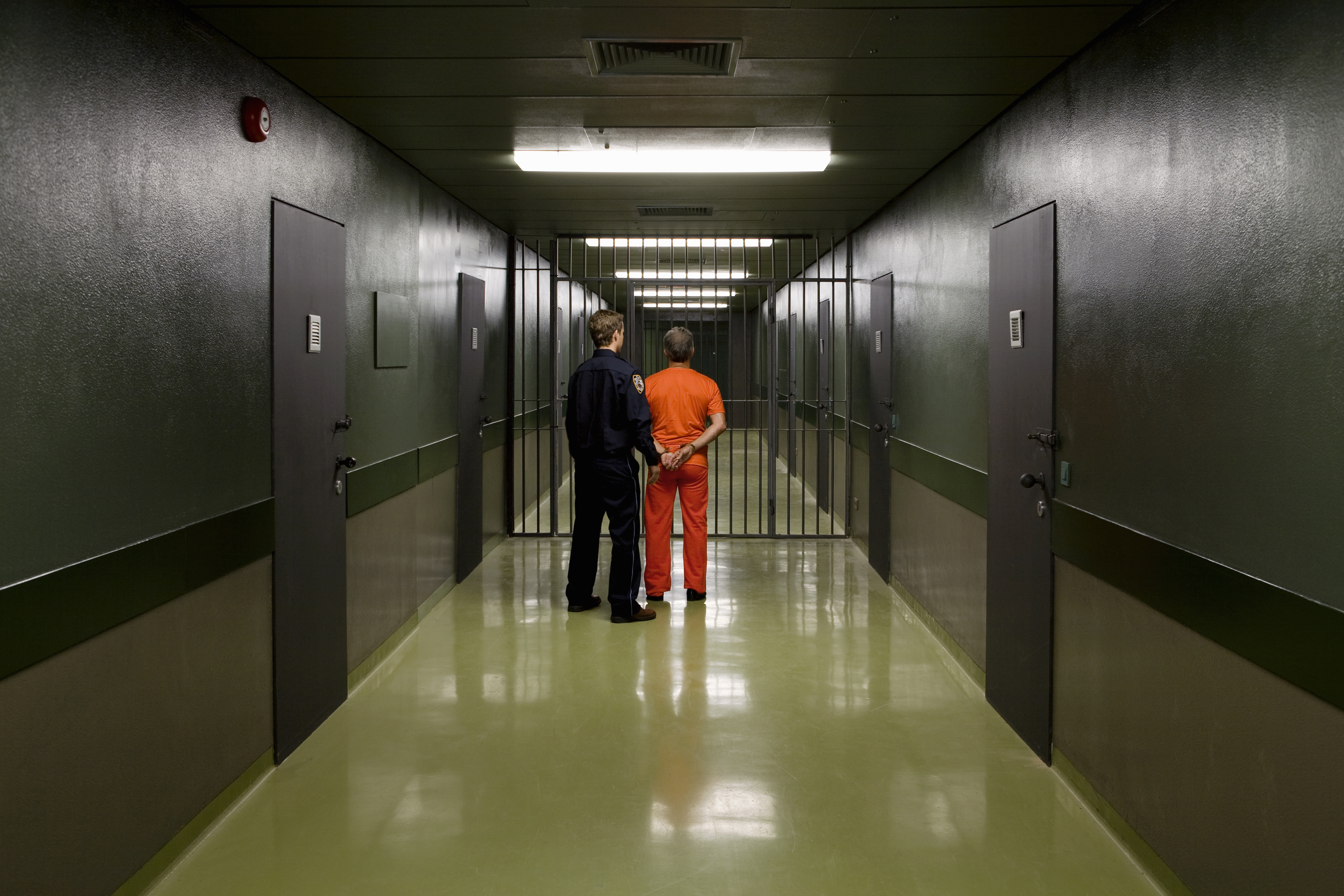 A prison guard leading a prisoner | Source: Getty Images