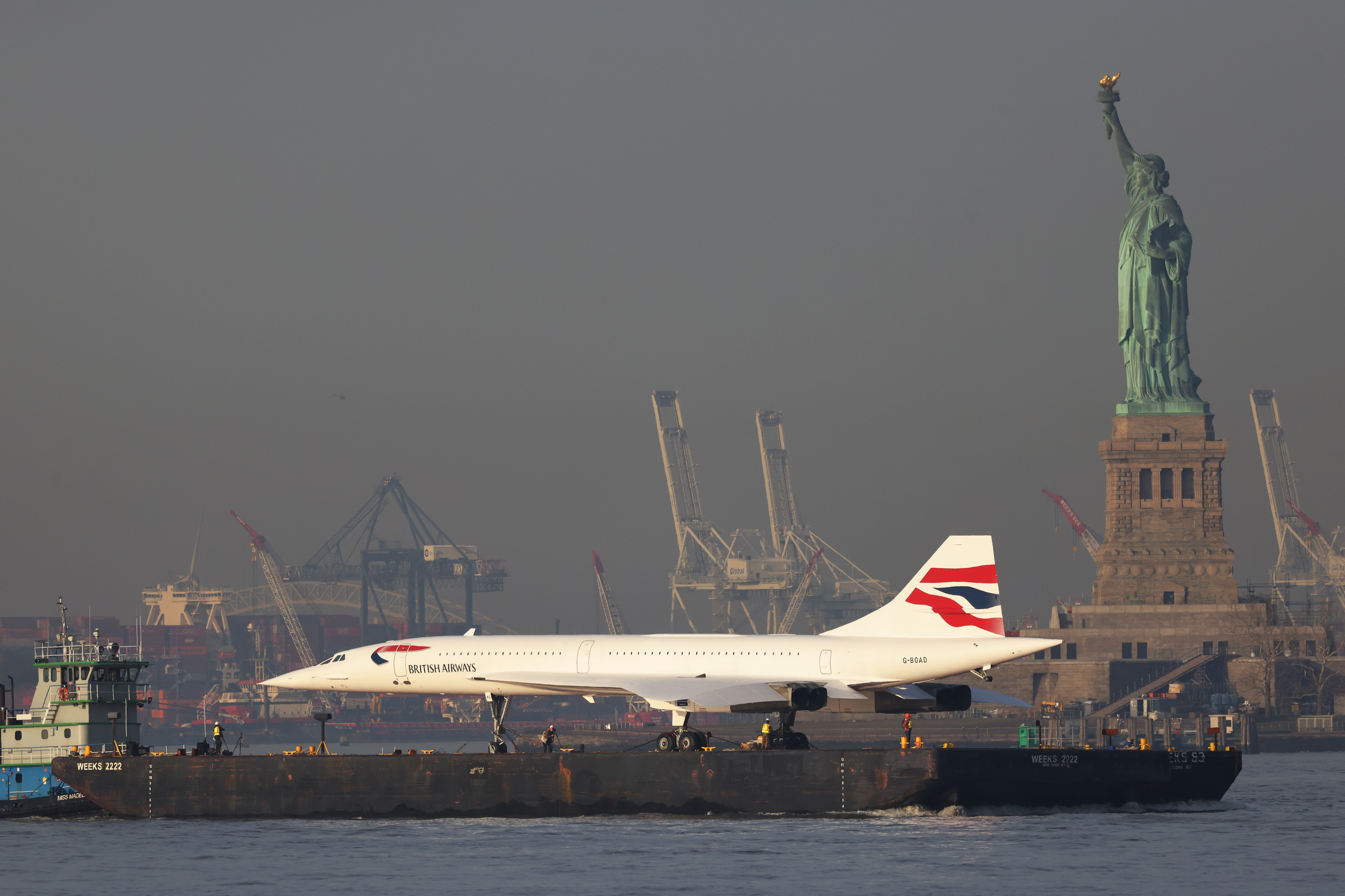 A retired British Airways Concorde supersonic airliner is moved by a barge past the Statue of Liberty on the Hudson River on March 14, 2024 in New York City | Source: Getty Images
