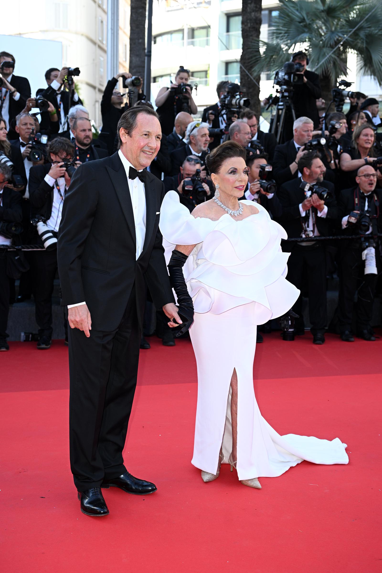 Percy Gibson and Dame Joan Collins attend the opening ceremony and "La Vénus Electrique" (The Electric Venus) screening during the 79th annual Cannes Film Festival on May 12, 2026 in France | Source: Getty Images