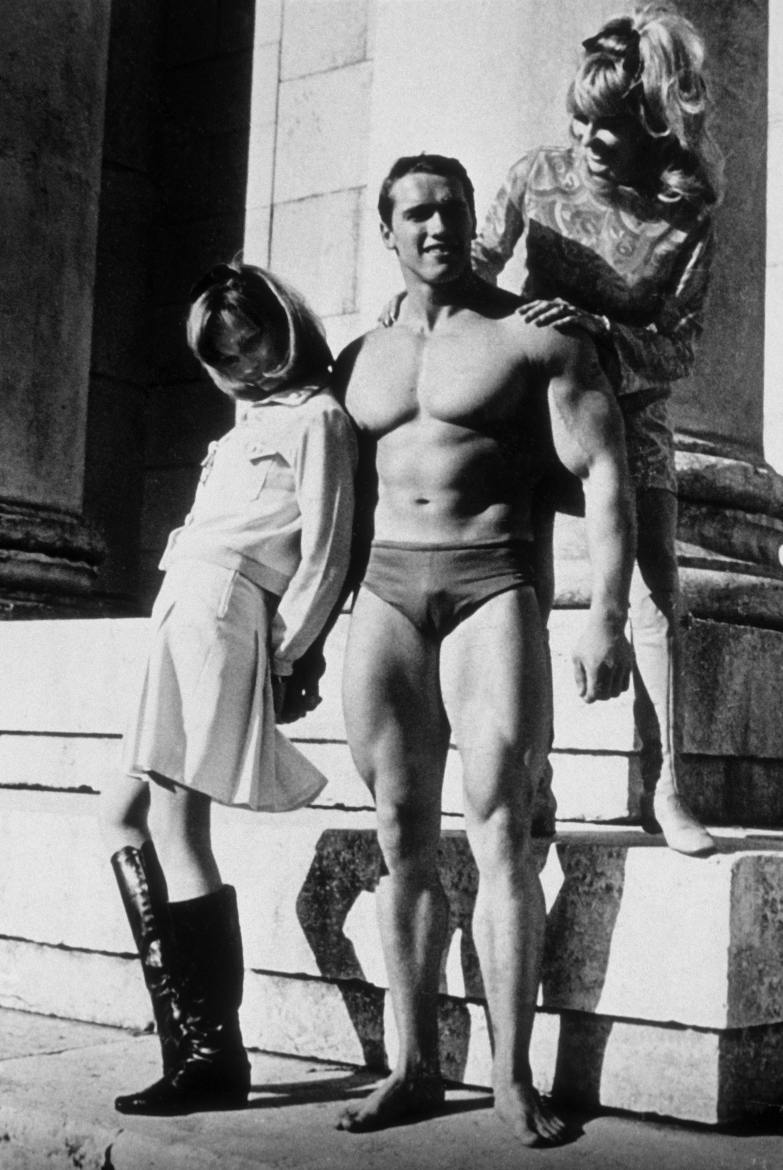 A young Arnold Schwarzenegger strikes a confident pose in Munich, West Germany, circa 1967, showcasing the physique that would launch his legendary career.
