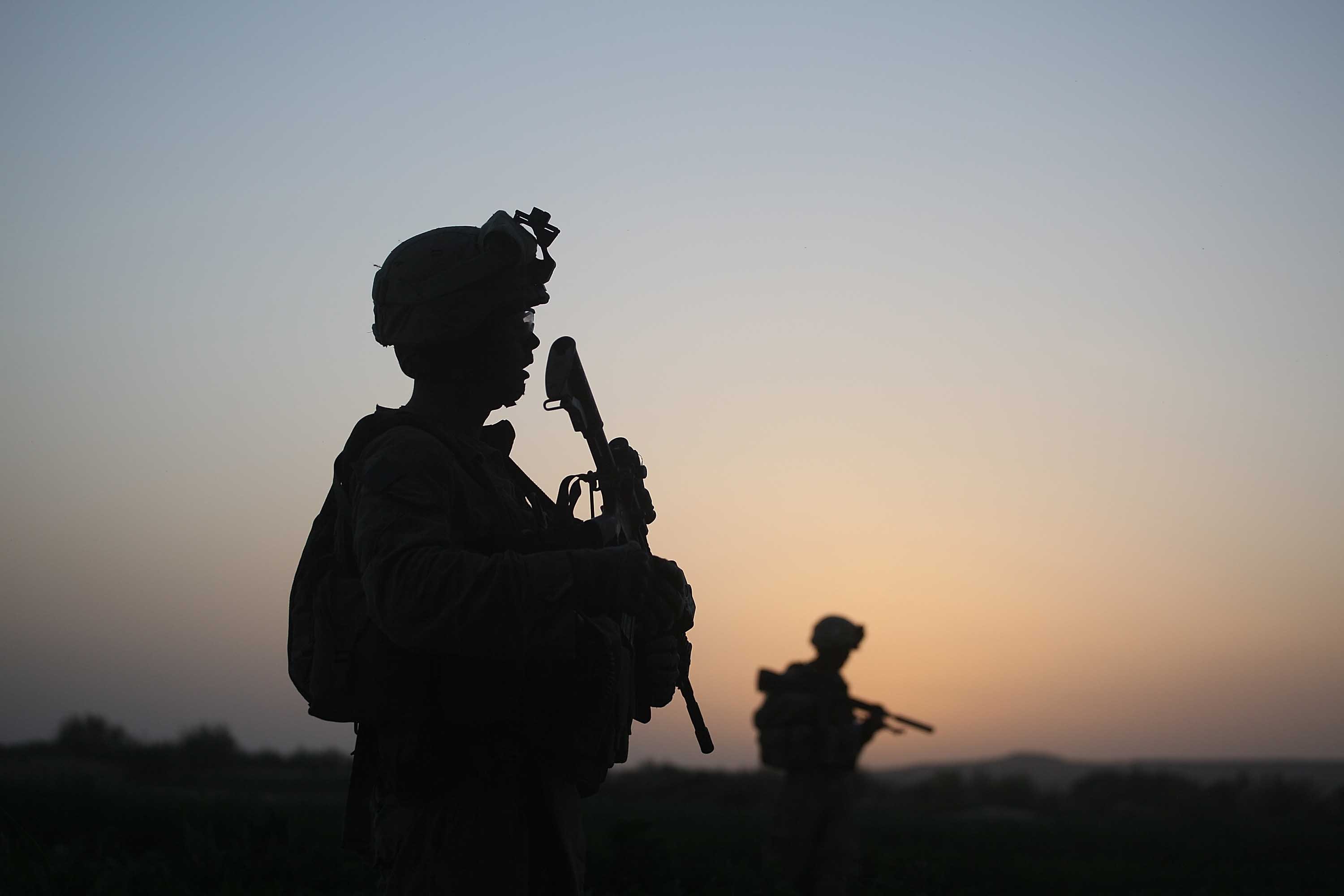 U.S. Marines with the 2nd Marine Expeditionary Brigade, RCT 2nd Battalion 8th Marines Echo Co. step off in the early morning during an operation to push out Taliban fighters on July 18, 2009 in Herati, Afghanistan | Getty Images: Photos