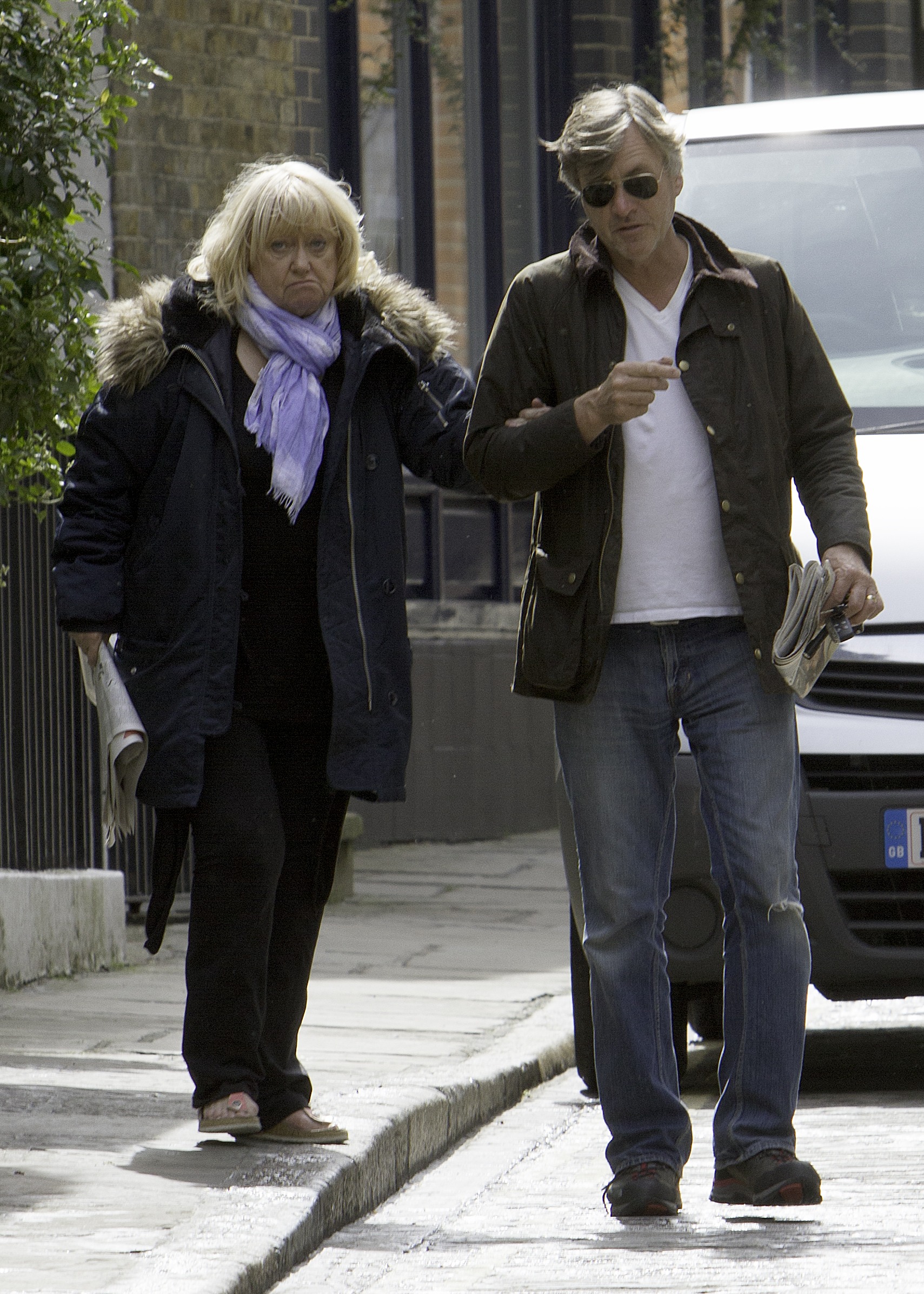 Judy Finnigan and Richard Madeley are photographed in London on 29 April 2016, walking side by side in a candid street moment that reflects their settled, off-camera life — a quieter chapter where their enduring partnership continues away from the intensity of their television years.