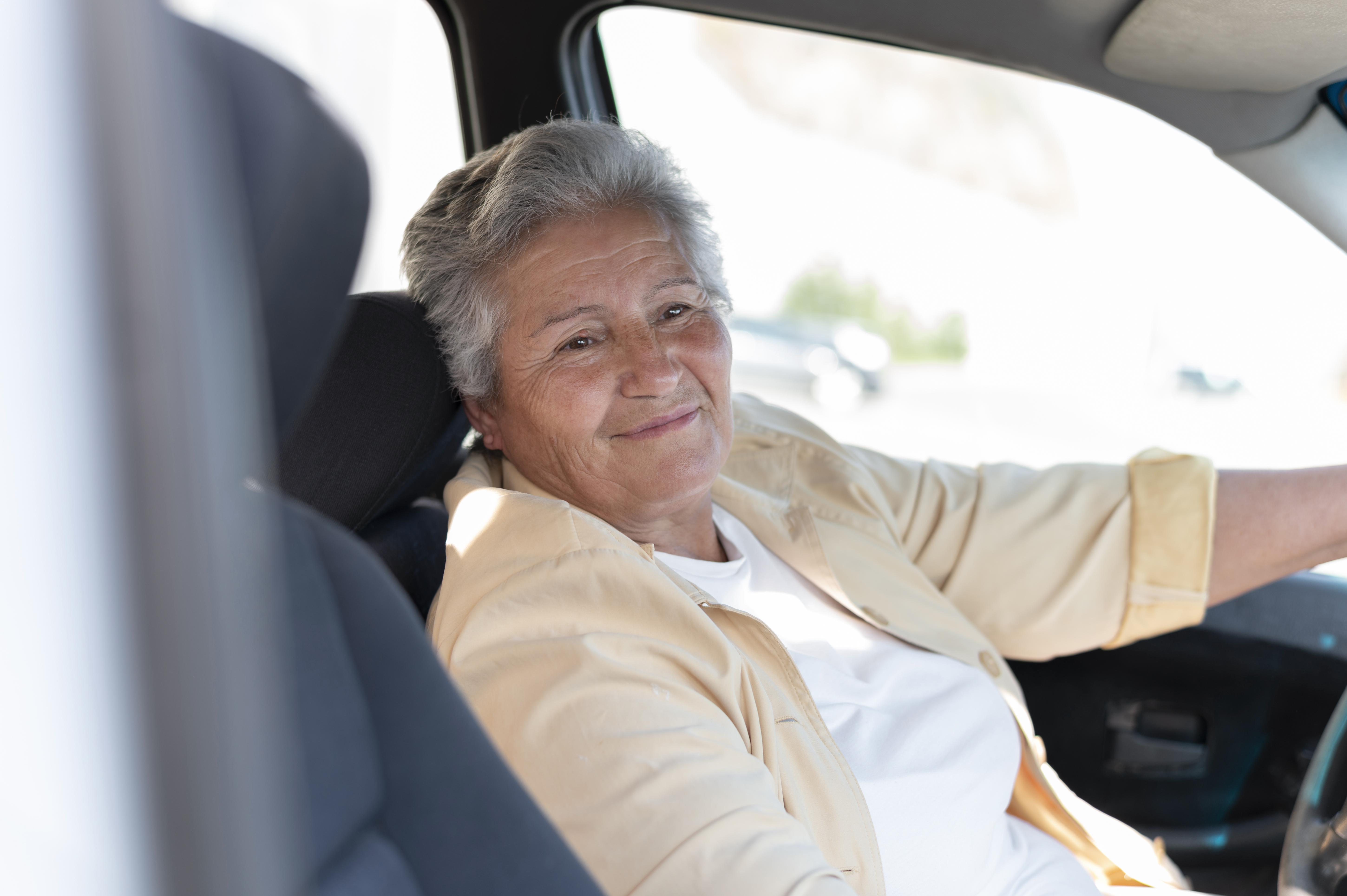 A senior woman driving a car | Source: Freepik