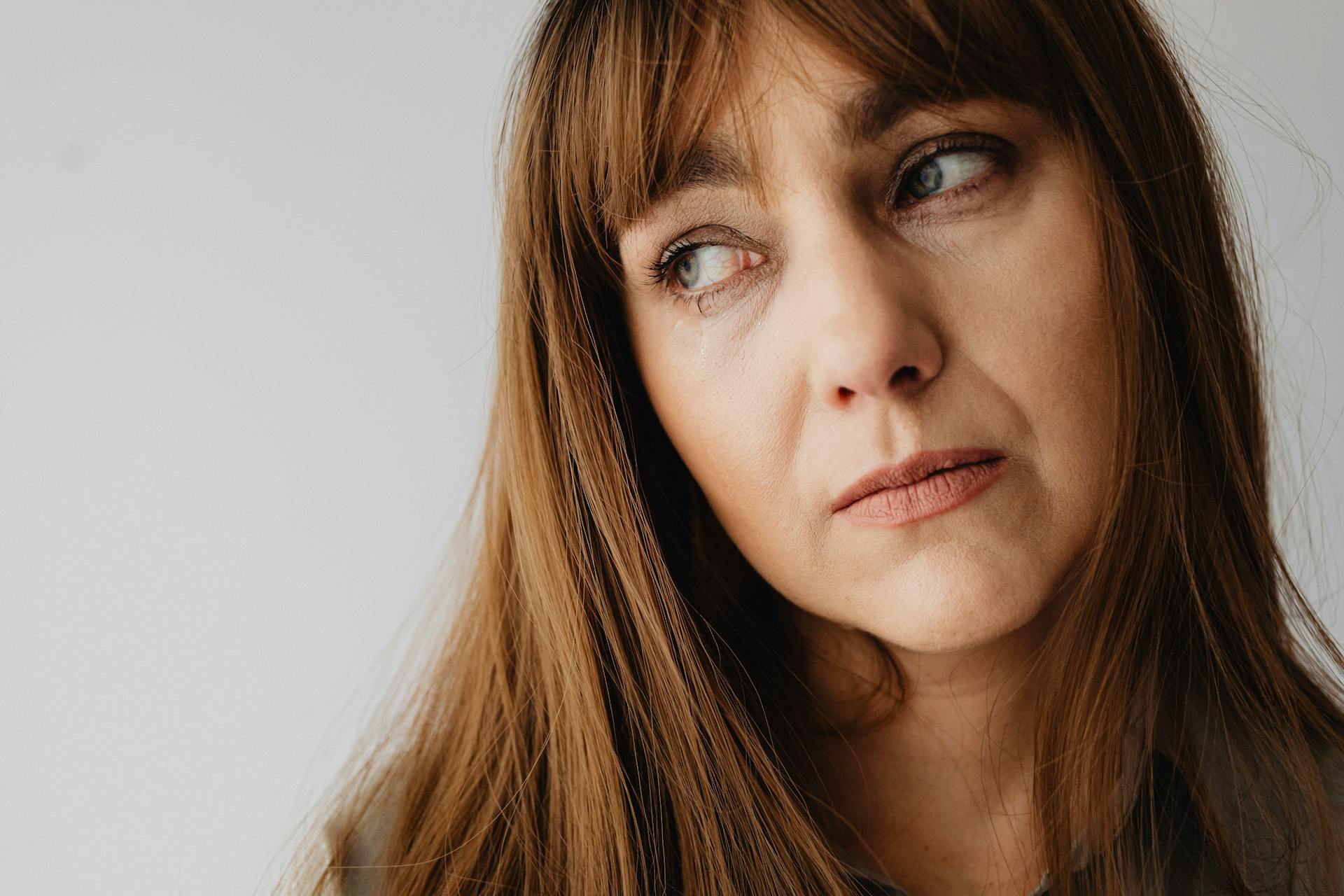 Close-up shot of woman with brown hair looking away | Source: Pexels