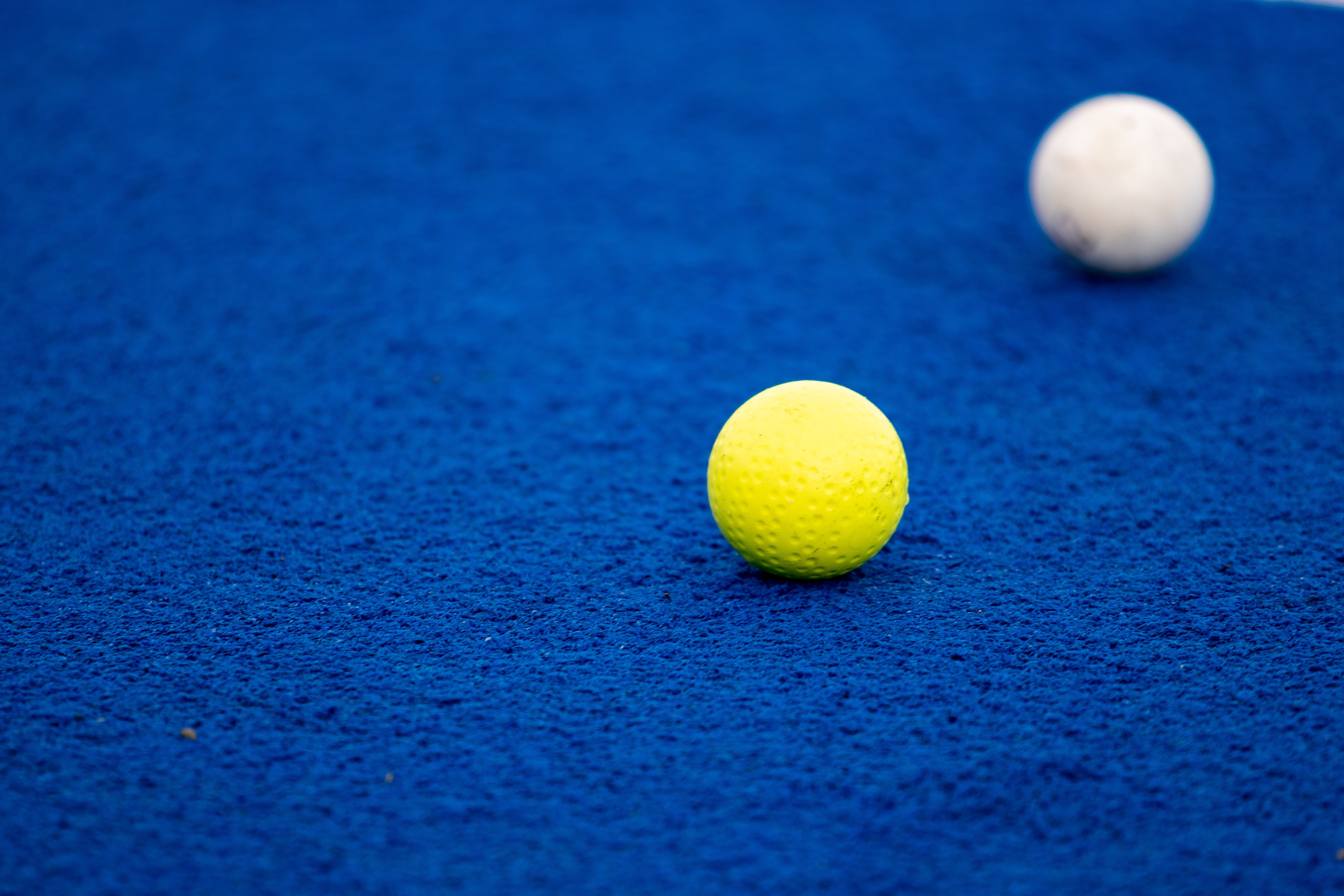 Pictured - An image of yellow and white gold balls on a blue carpet | Source: Pexels 