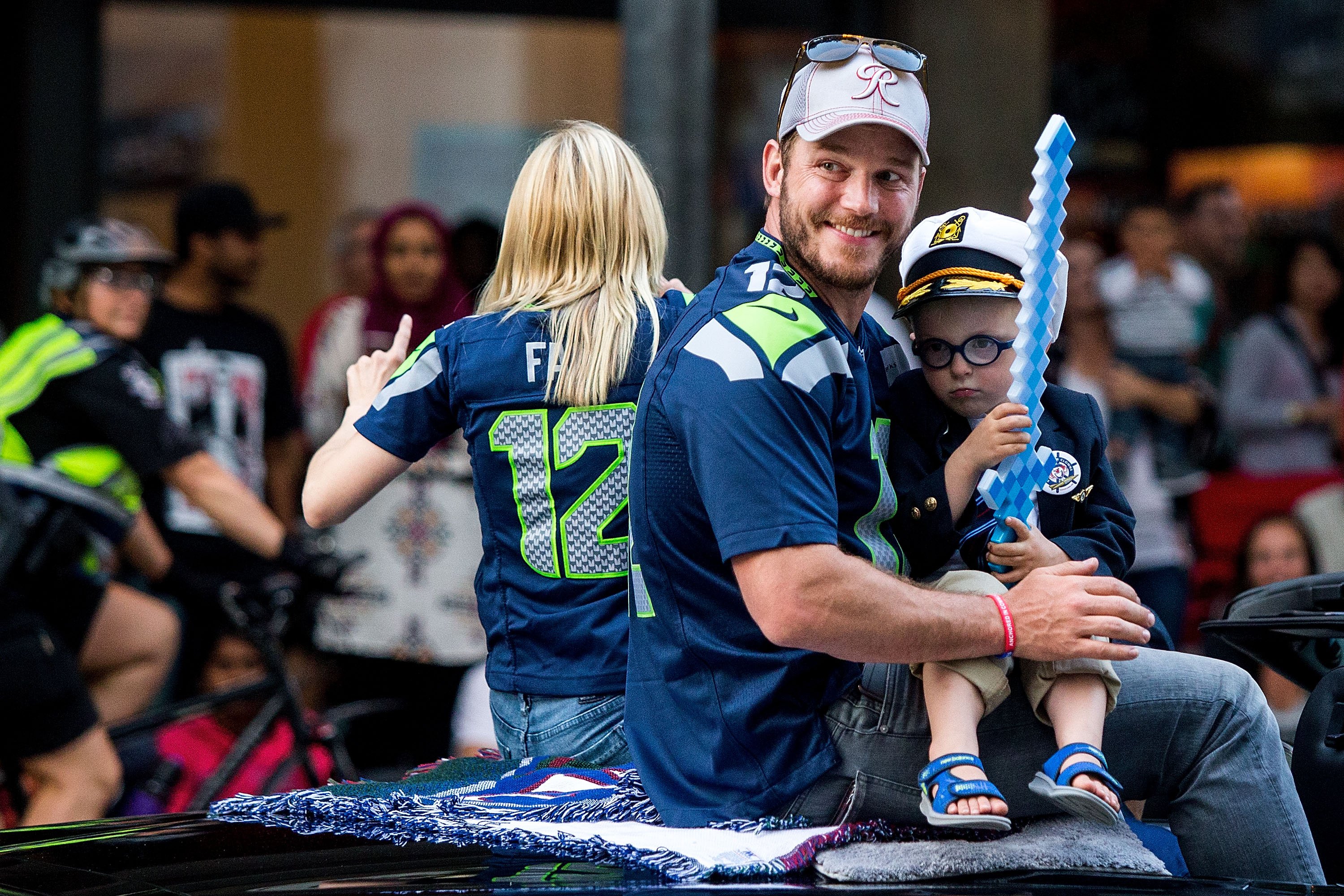 Actor Chris Pratt and son Jack Pratt ride in the Seafair Torchlight Parade Grand Marshal vehicle on July 30, 2016, in Seattle, Washington. | Source: Getty Images
