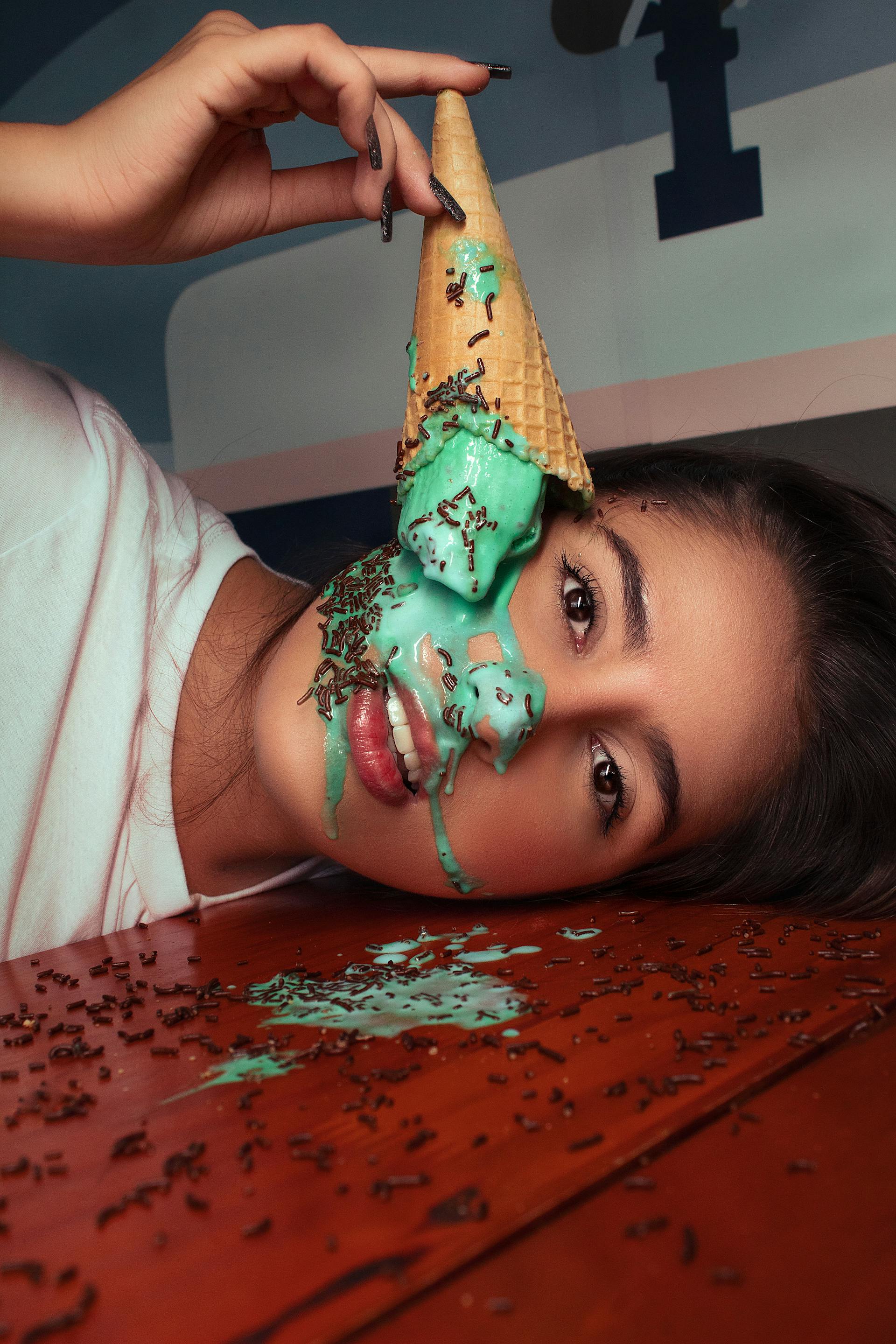 Ice cream dripping from a cone on a woman's face | Source: Pexels