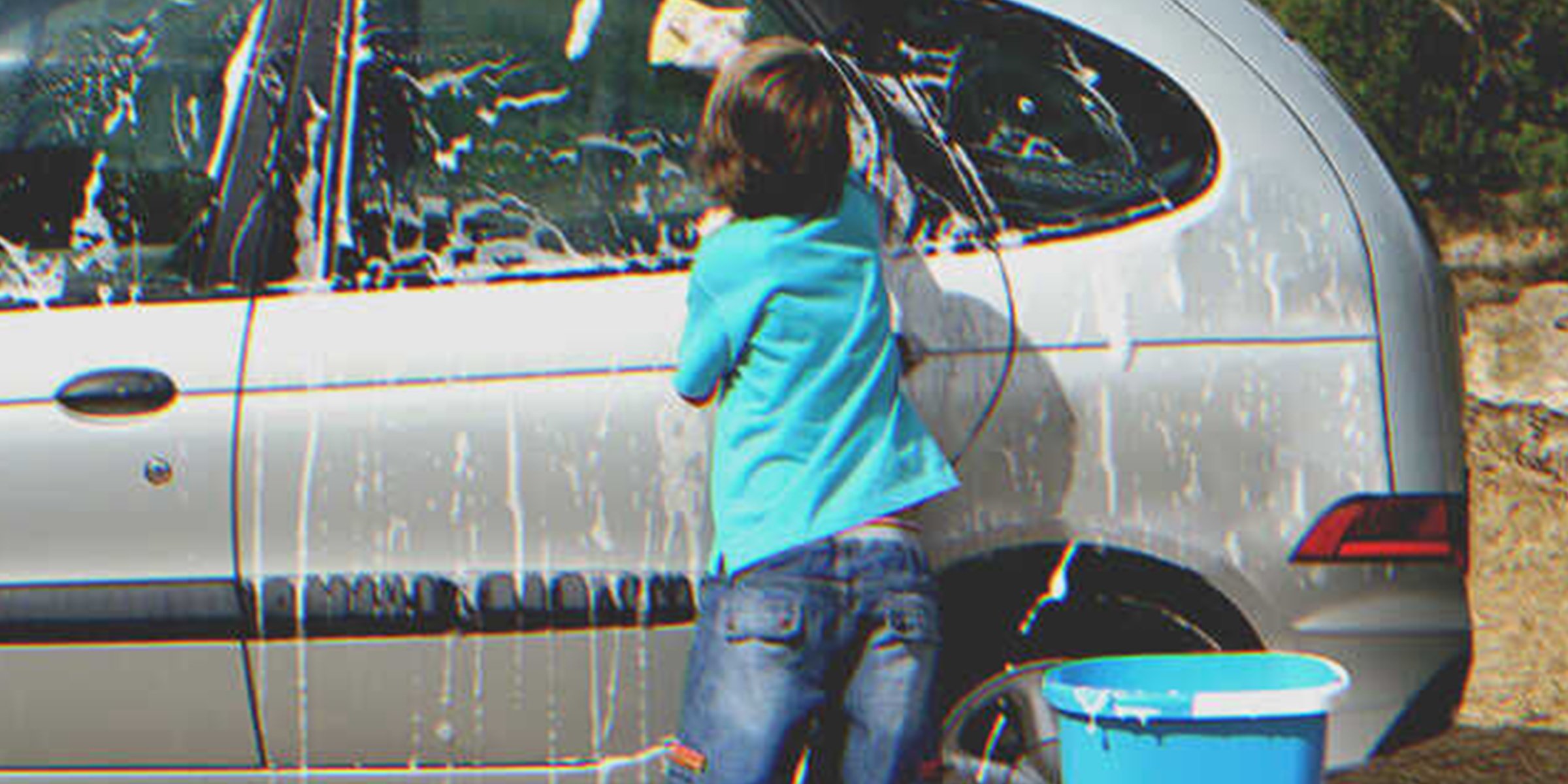 Boy washing car | Source: Getty Images
