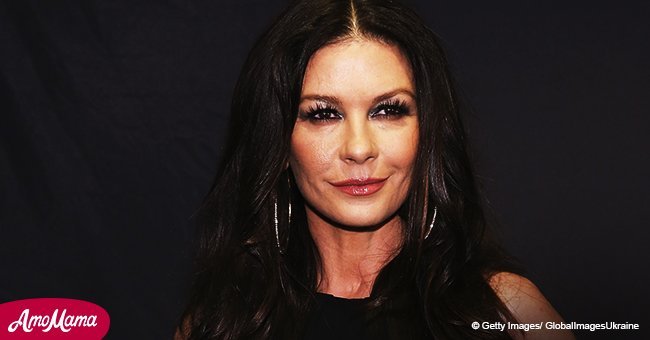 Catherine Zeta-Jones shows off her svelte figure in a plunging navy dress during recent appearance