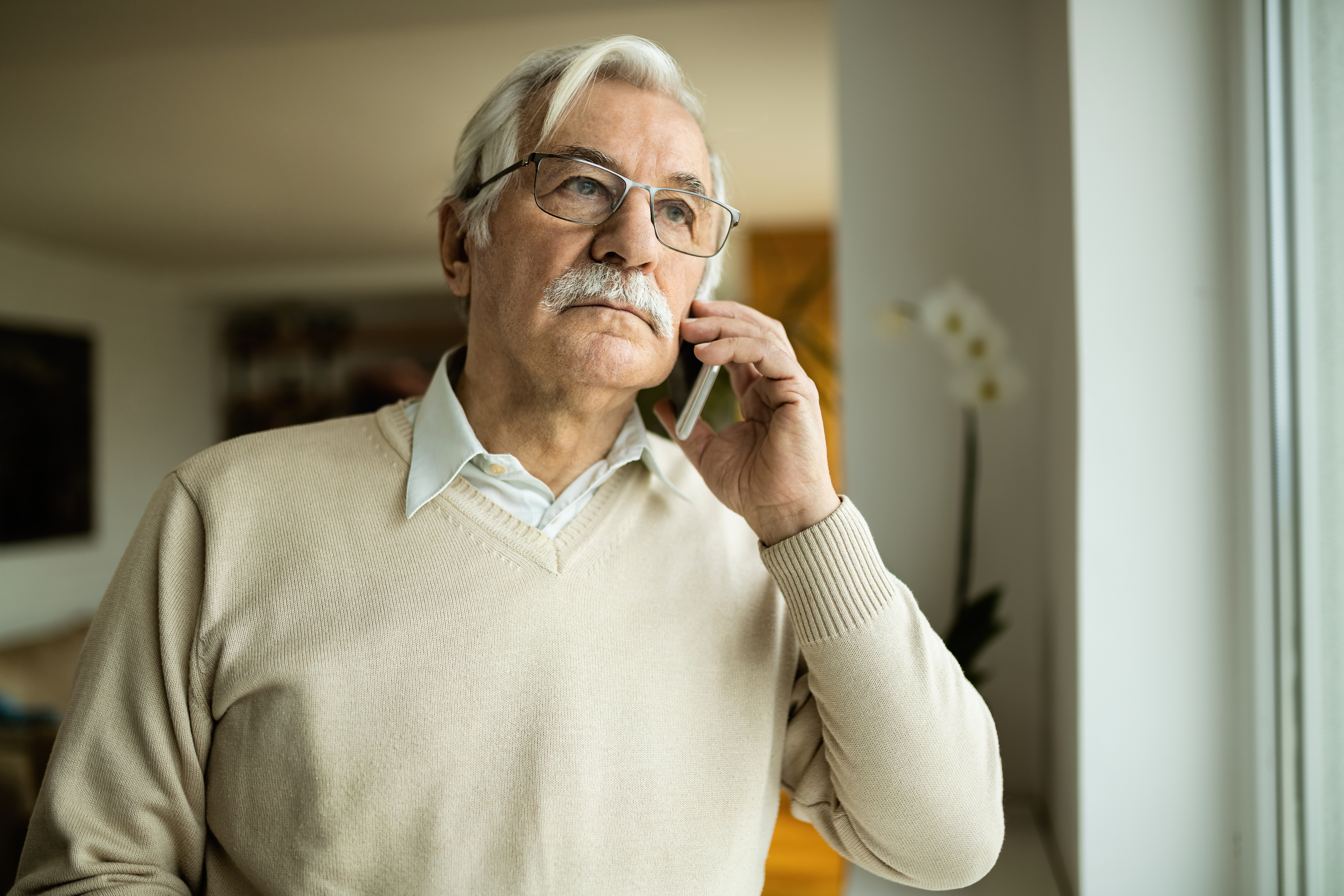 A senior man talking on the phone | Source: Shutterstock