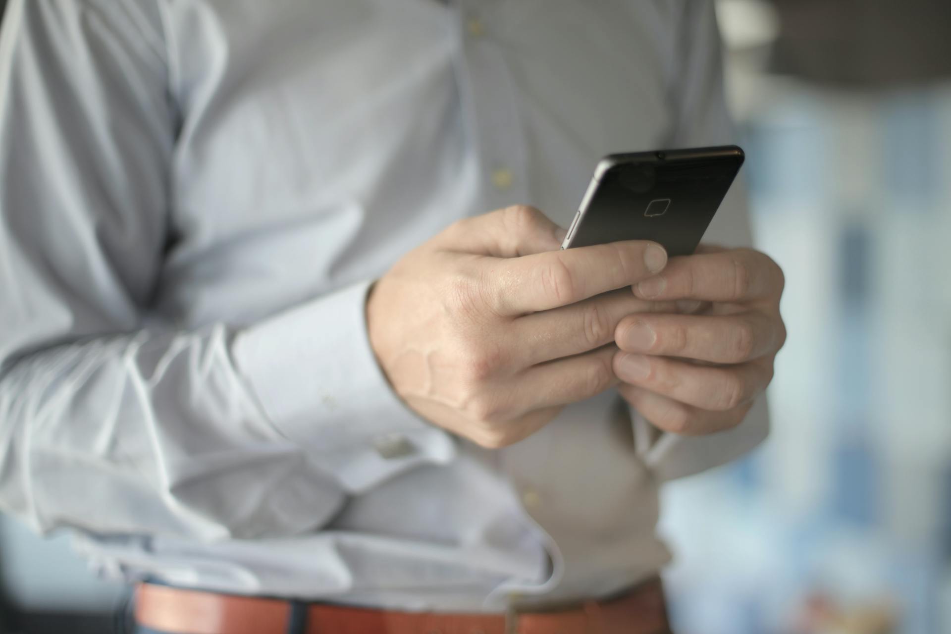 A closeup shot of a man using a phone | Source: Midjourney