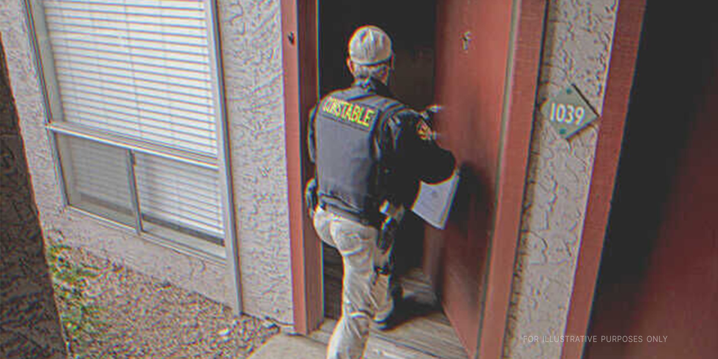 Policeman going into a house. | Source: Getty Images