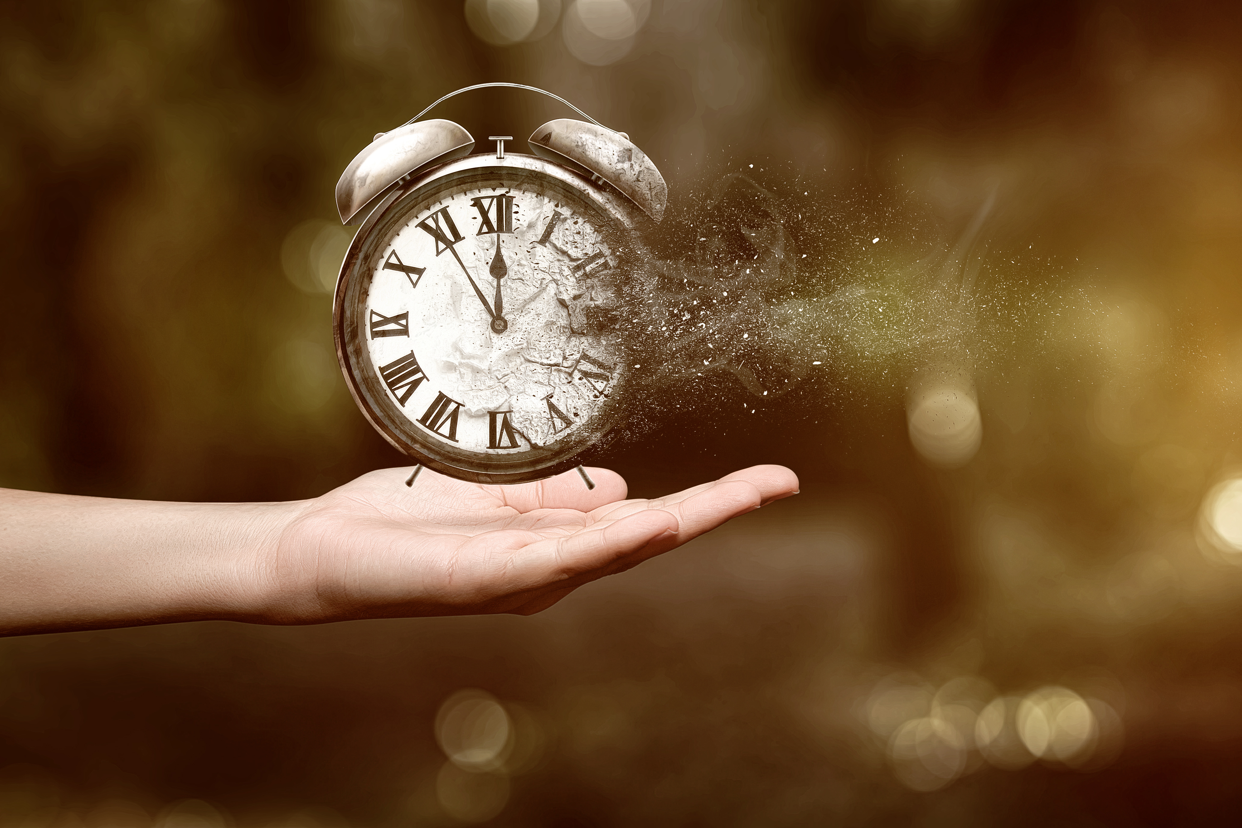 A hand holding a disappearing clock | Source: Shutterstock