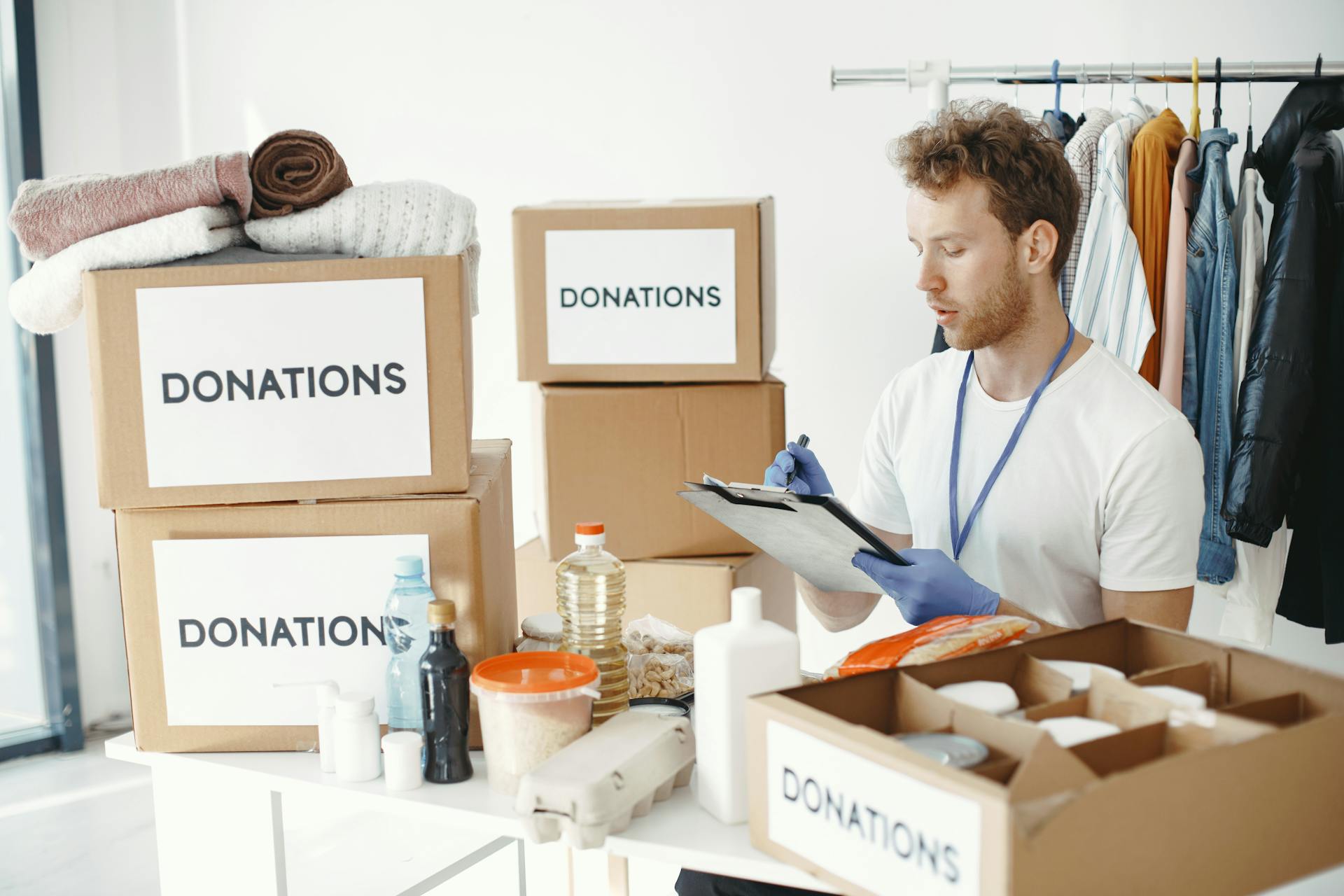 A charity worker checking donation boxes | Source: Pexels