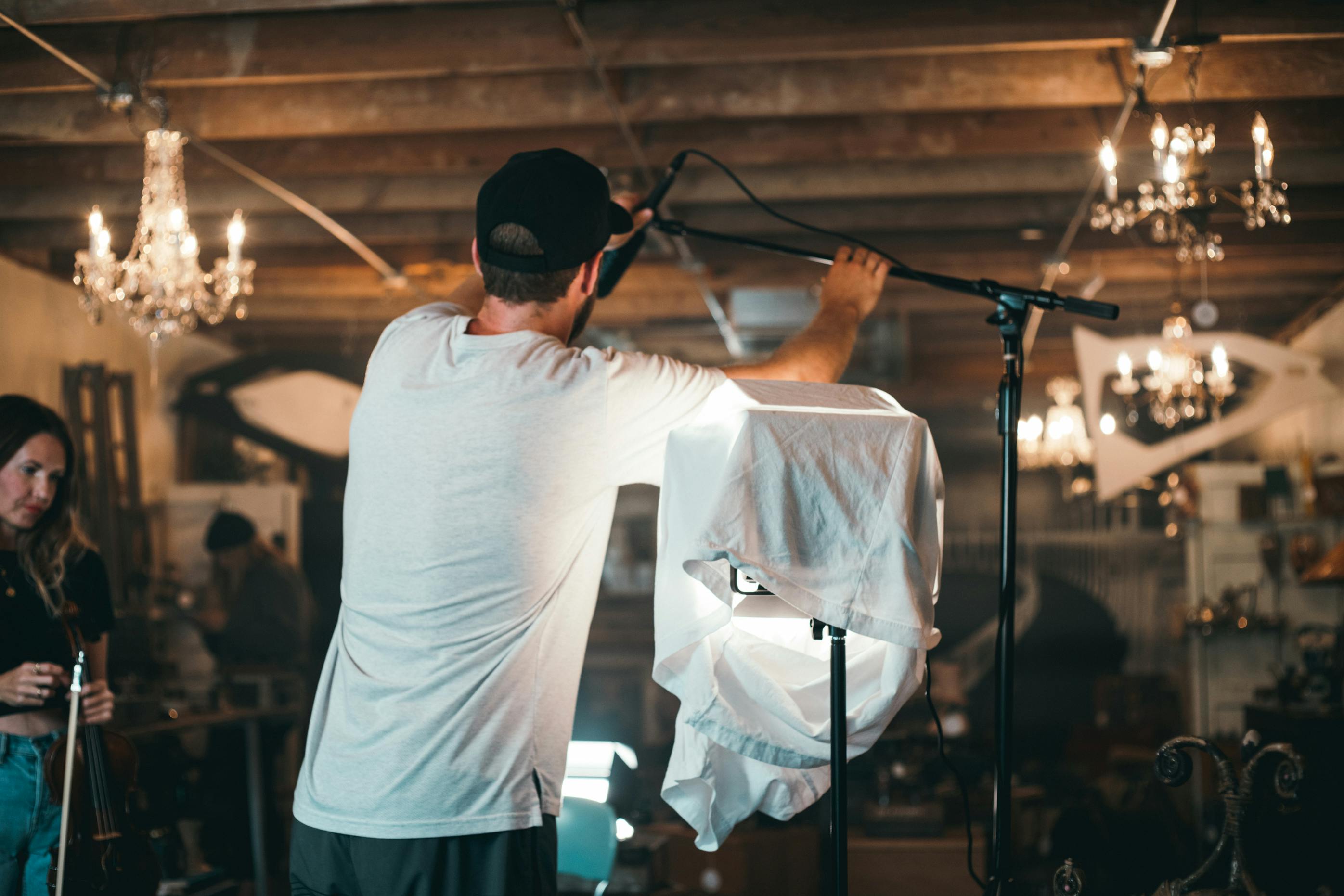 A man positions a microphone | Source: Pexels
