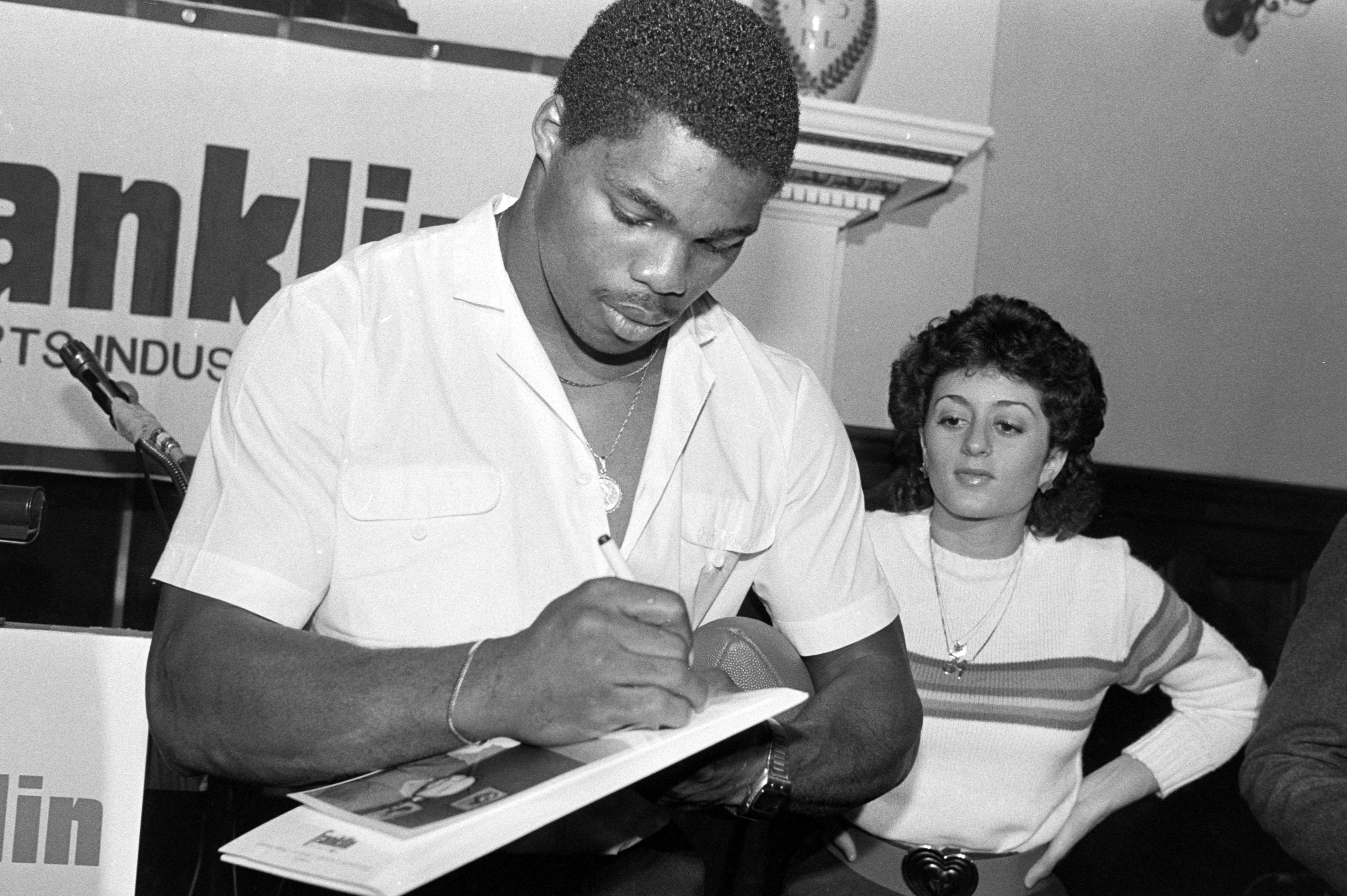 Herschel Walker and Cindy DeAngelis Grossman at Franklin Sports Industries conference on April 5, 1983 | Source: Getty Images