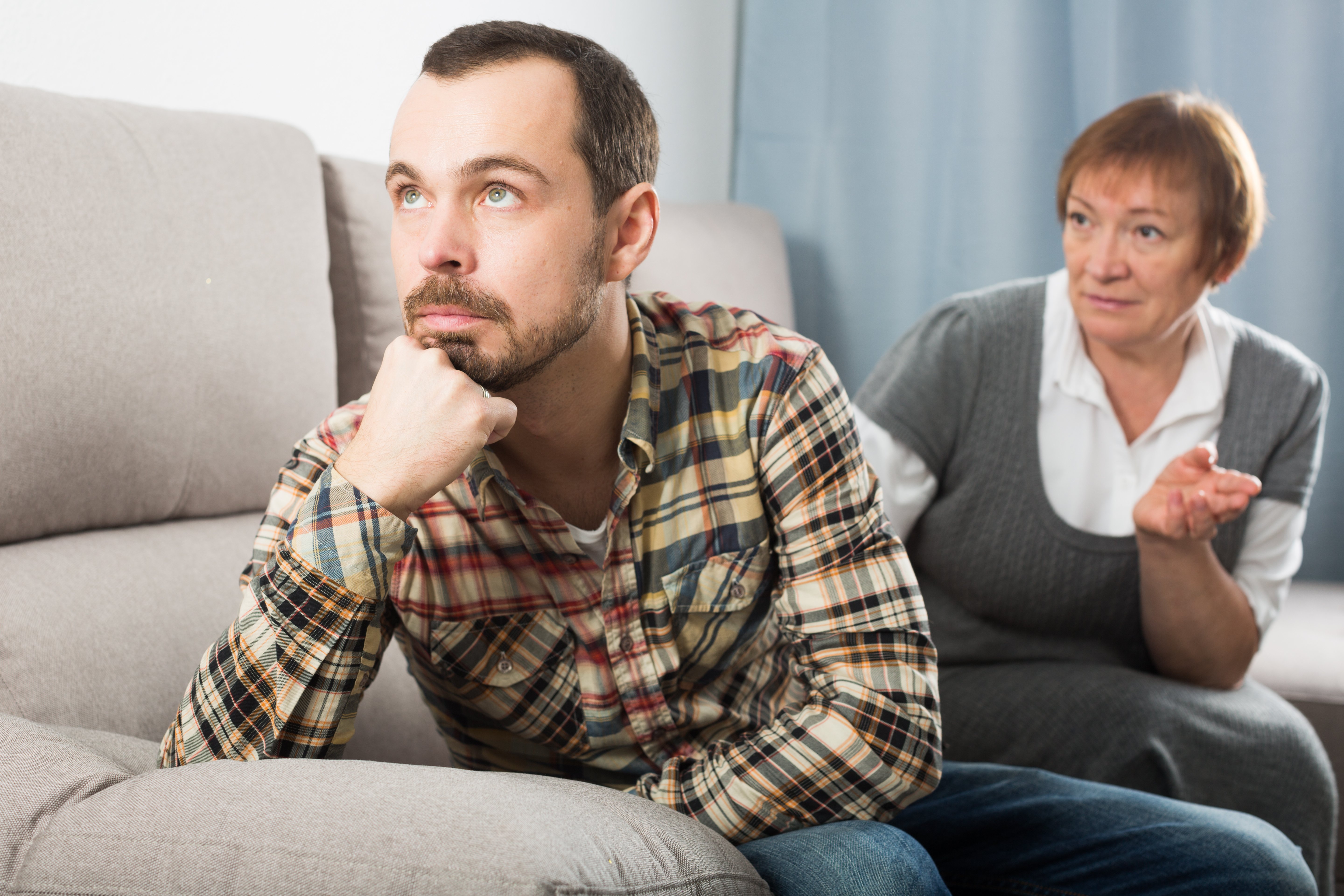 Older woman and her son arguing | Source: Shutterstock