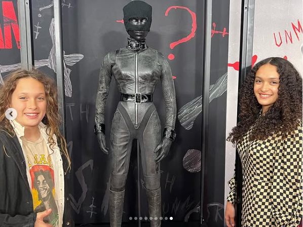 Jason Momoa's children: Nakoa-wolf and Lola posing with a replica of Zoe Kavitz's iconic Catwoman suit, at the "Batman" screening on March 3, 2022 | Source: Instagram/prideofgypsies