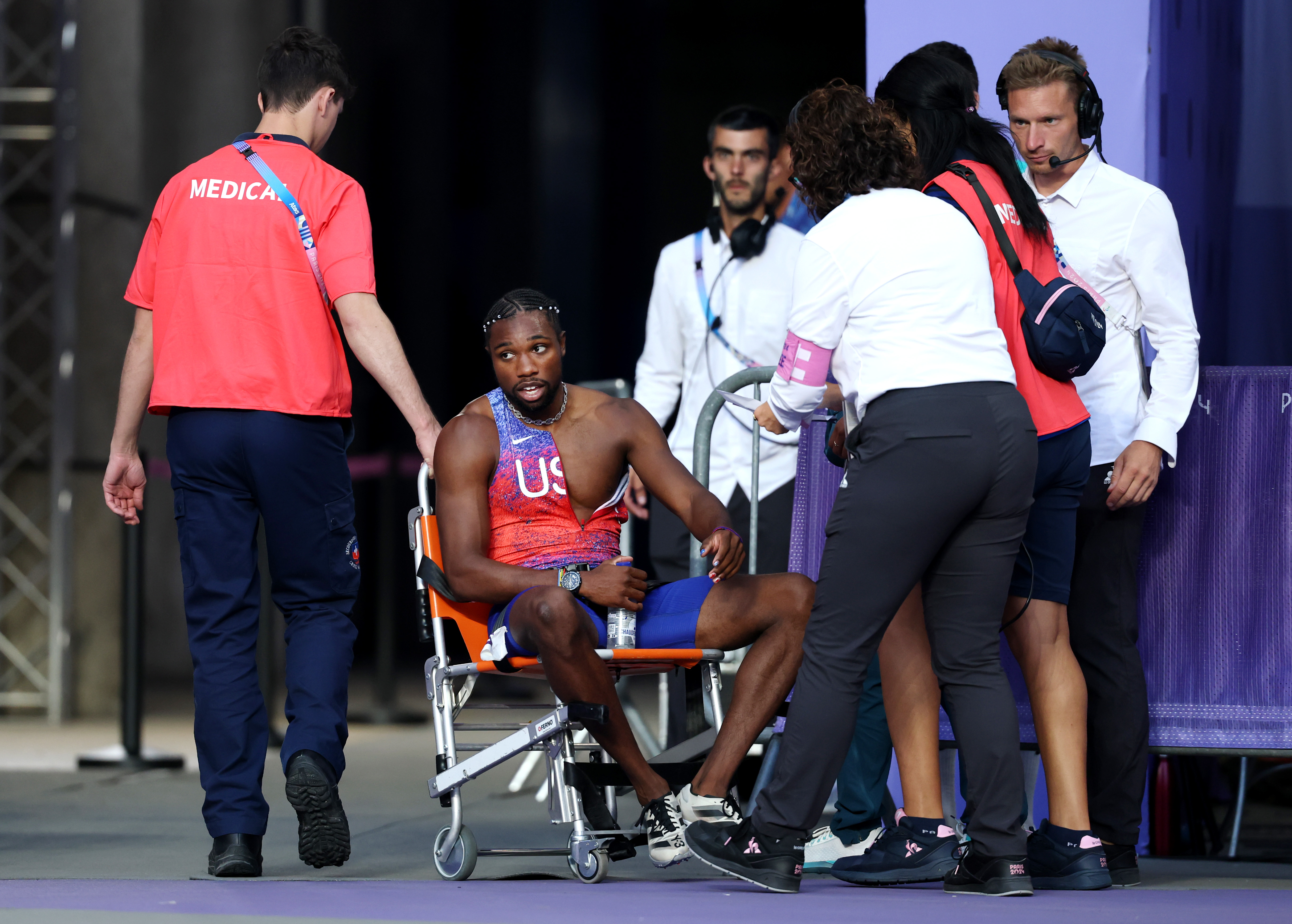 Noah Lyles of Team US taken off from the track with a wheelchair after competing in the Men's 200m Final at the Paris Olympic Games on August 8, 2024, in Paris, France | Source: Getty Images