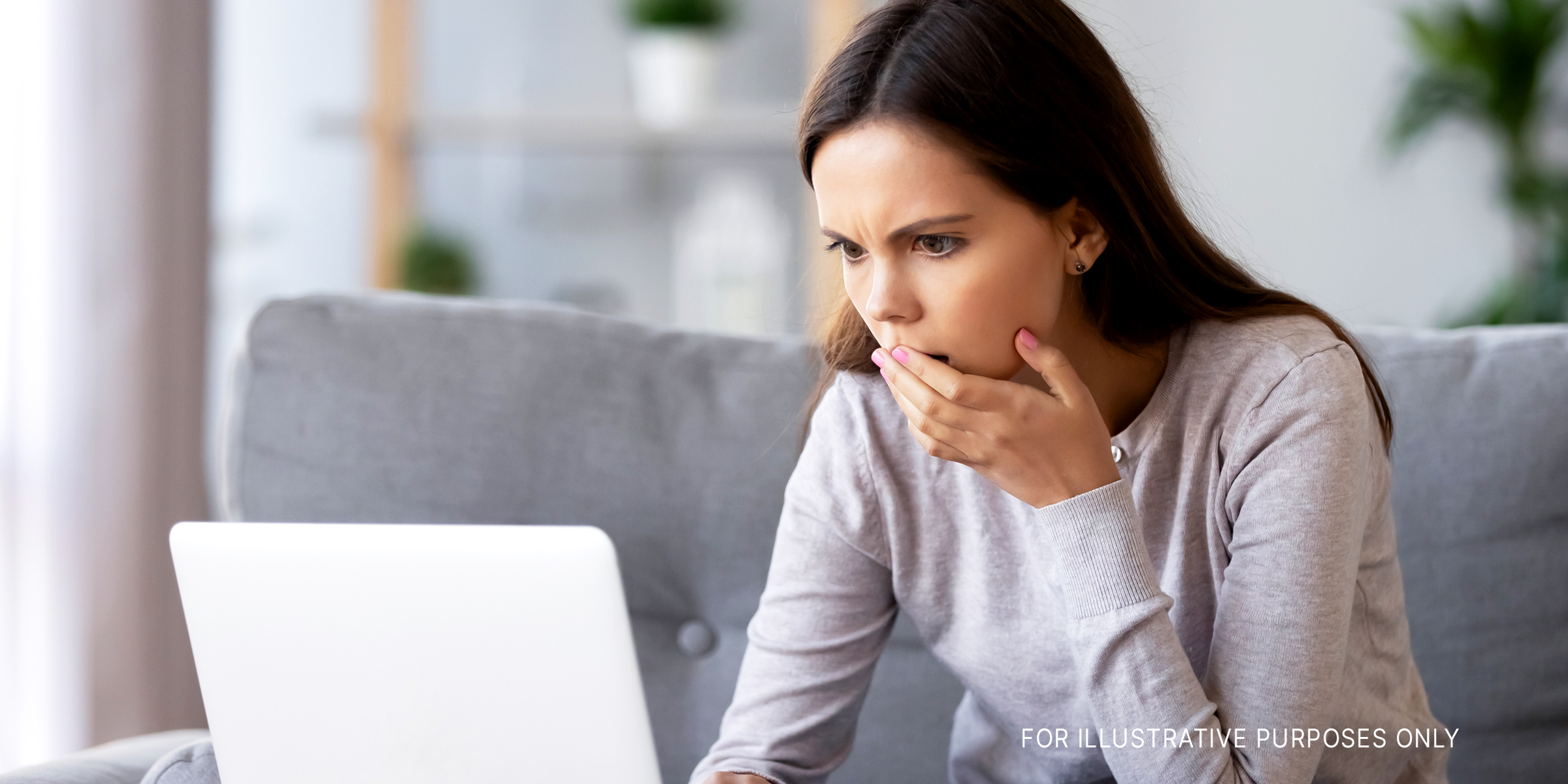 A shocked young woman looking at her laptop screen | Source: Shutterstock