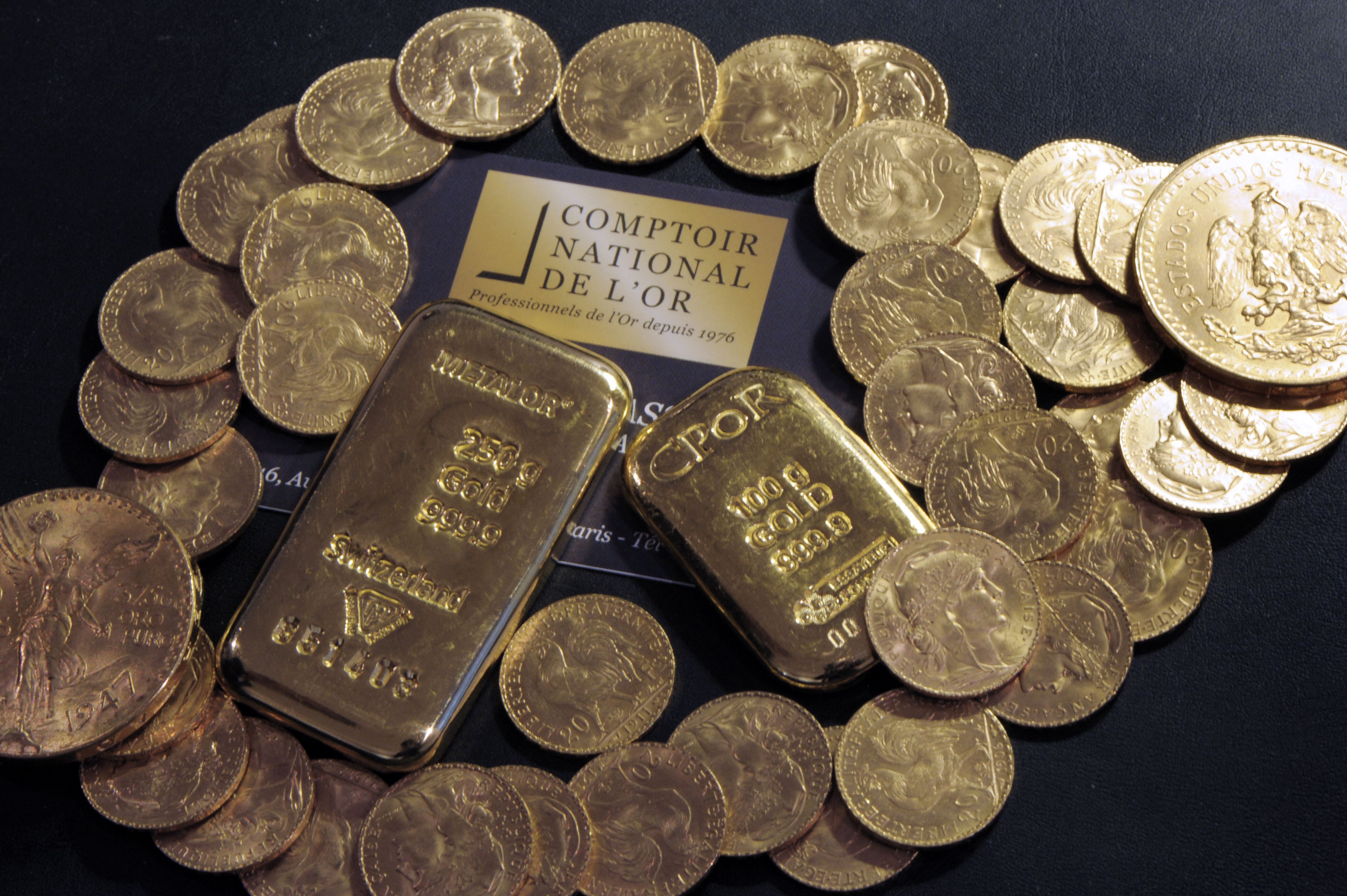 Photo of gold bars and coins displayed on a table at the Comptoir National de l'Or, a shop that buys, sales and estimates gold and jewellery on October 5, 2012 in Paris. | Source: Getty Images/BERTRAND GUAY/AFP