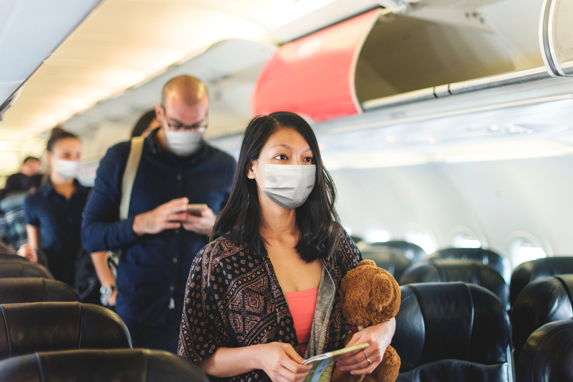 Passengers standing in the aisle | Source: Freepik