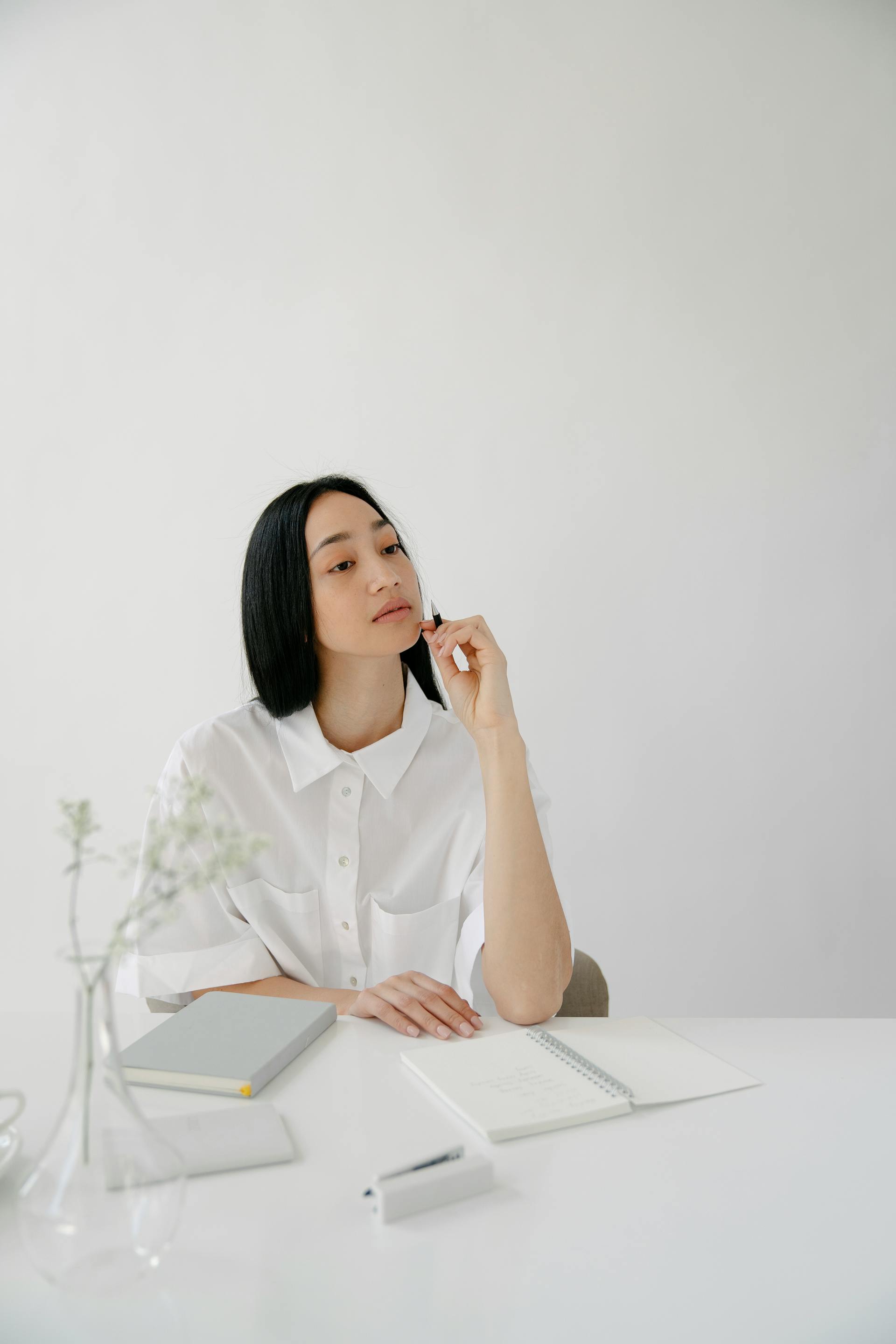 A woman at a desk peering down her nose | Source: Pexels