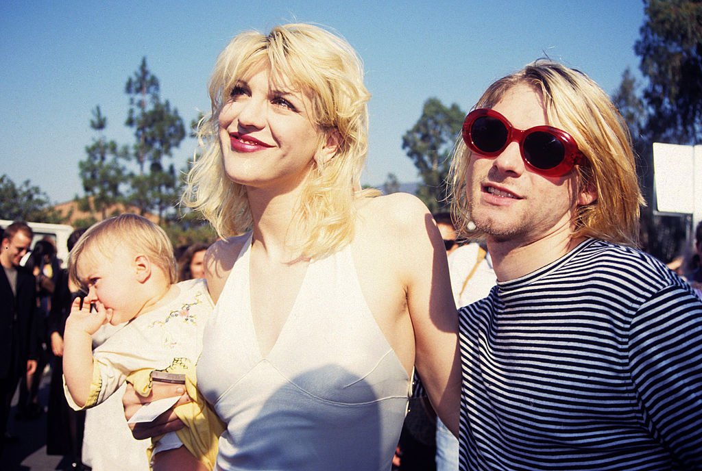 Kurt Cobain of Nirvana (right) with wife Courtney Love and daughter Frances Bean Cobain at the Universal Ampitheater in Universal City, California on September 02, 1993 | Photo: Getty Images
