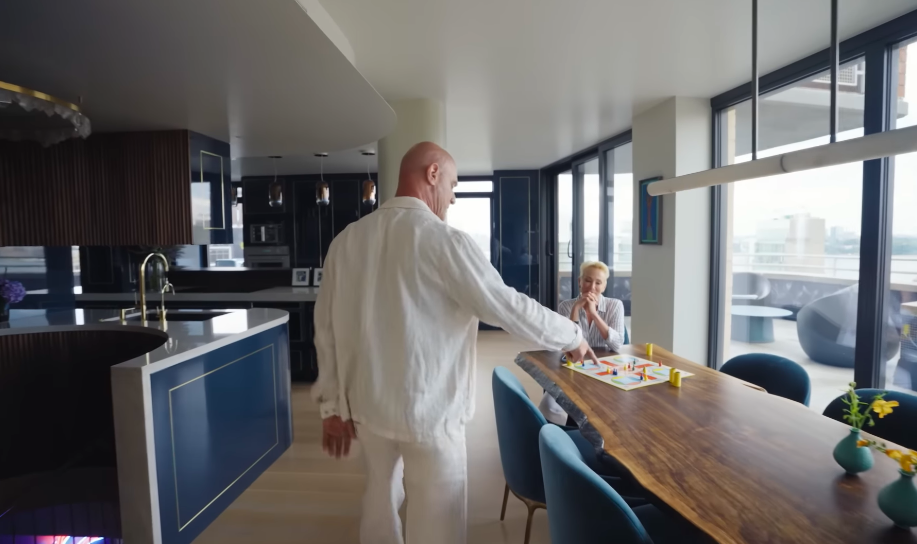 The very serious dining table apparently doubles as game-night headquarters. Christopher teased that Sherman sets up the Parcheesi board early so she can "cheat before we play." | Source: YouTube/Architectural Digest